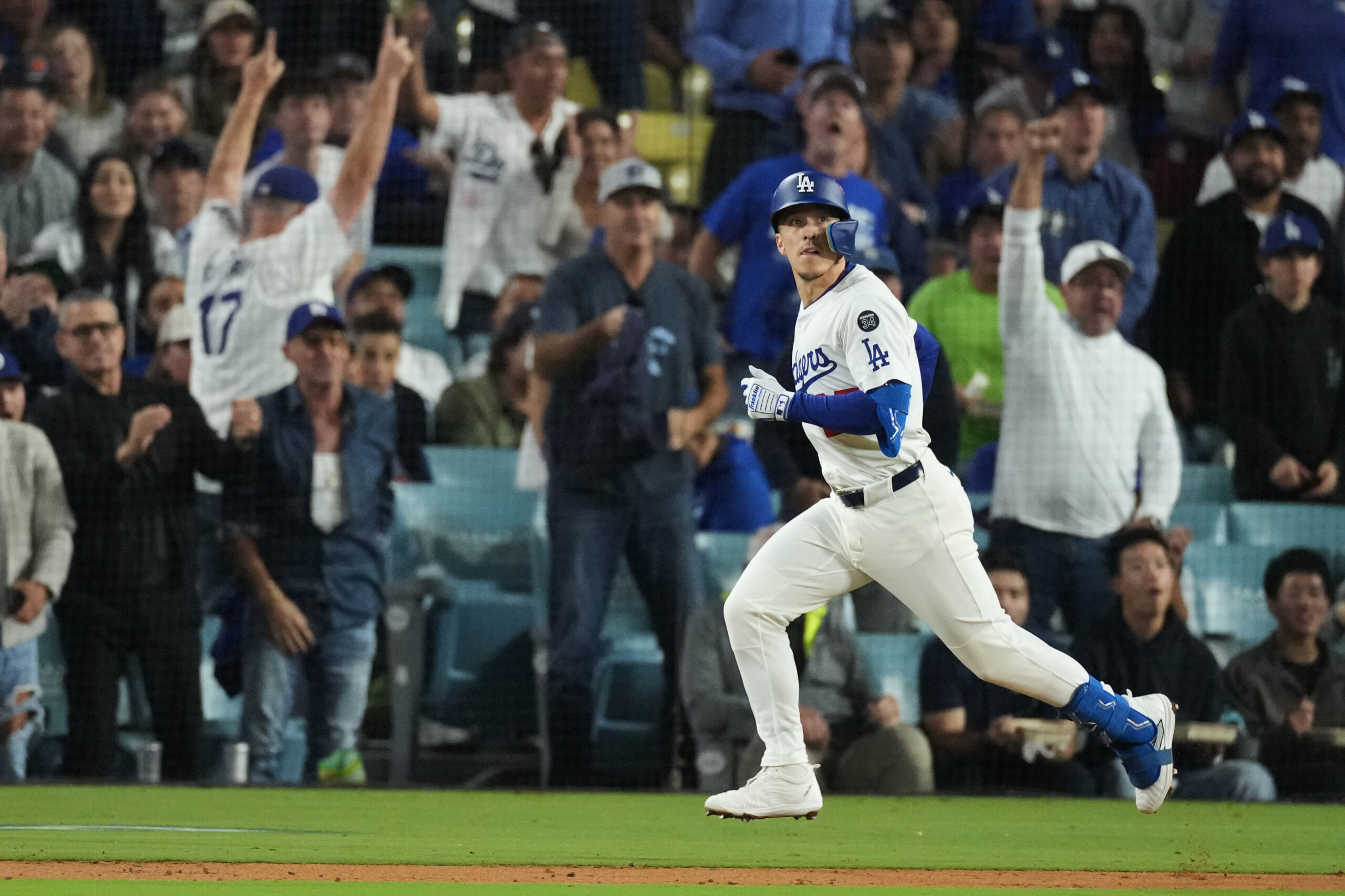 The Dodgers’ Tommy Edman watches his solo home during the...