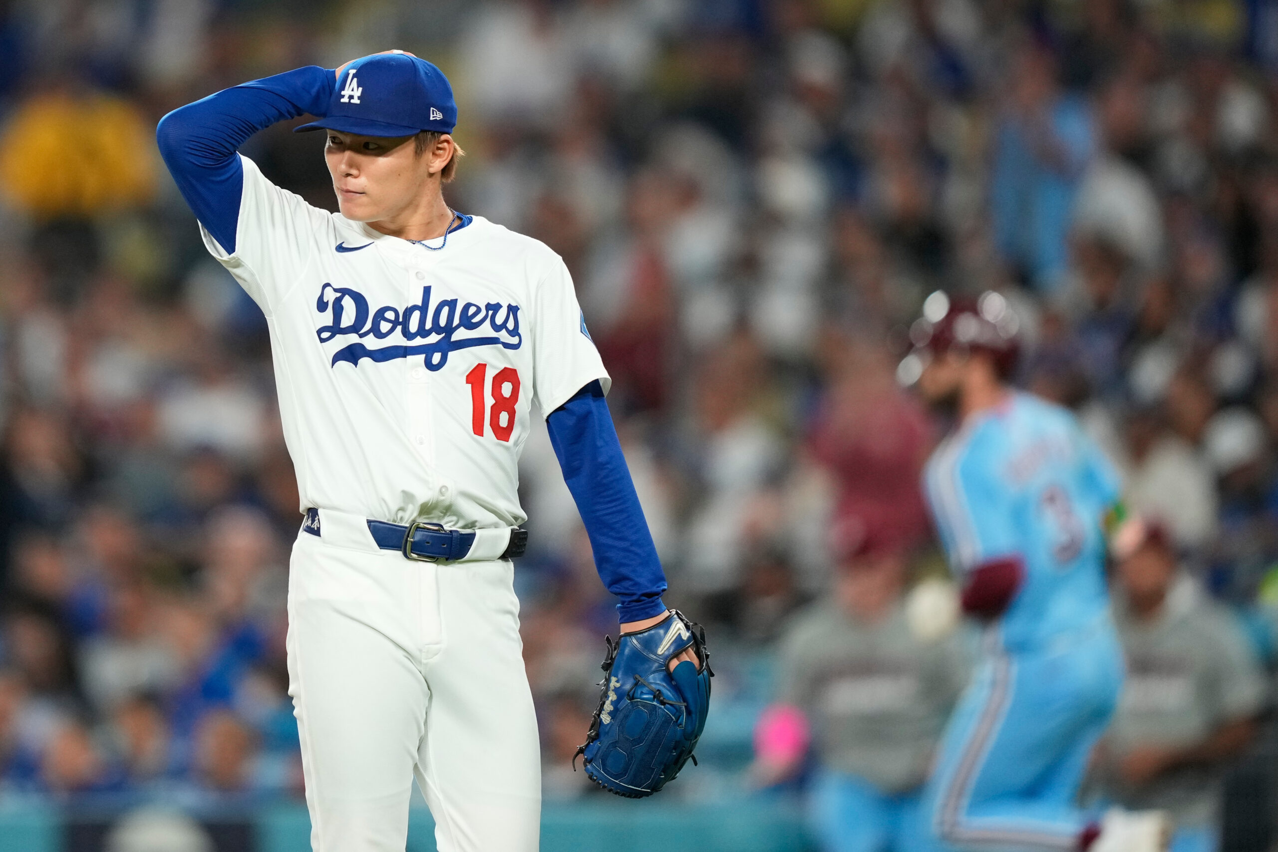 Dodgers starting pitcher Yoshinobu Yamamoto walks off the mound during...