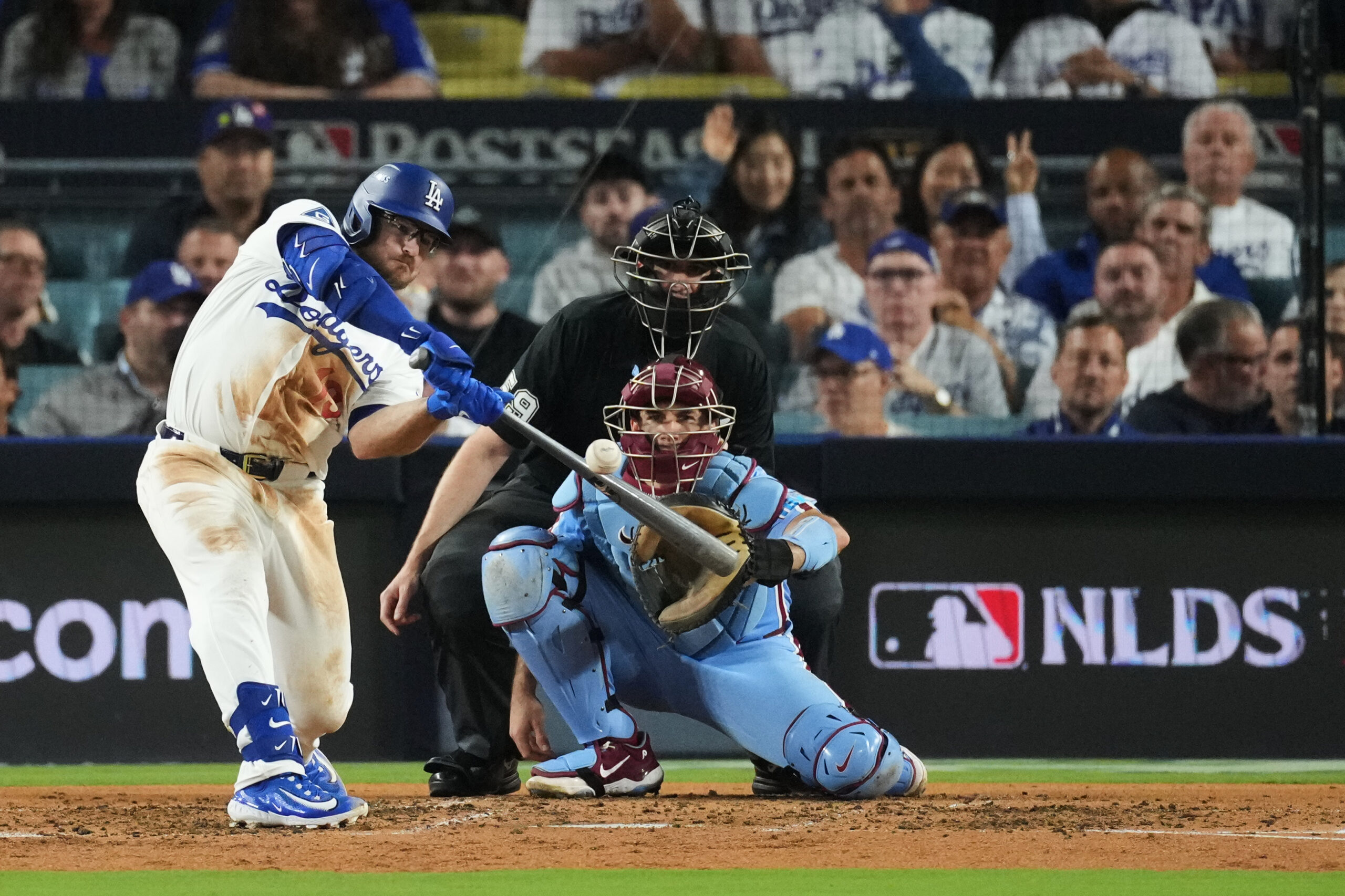 The Dodgers’ Max Muncy connects for a single during the...