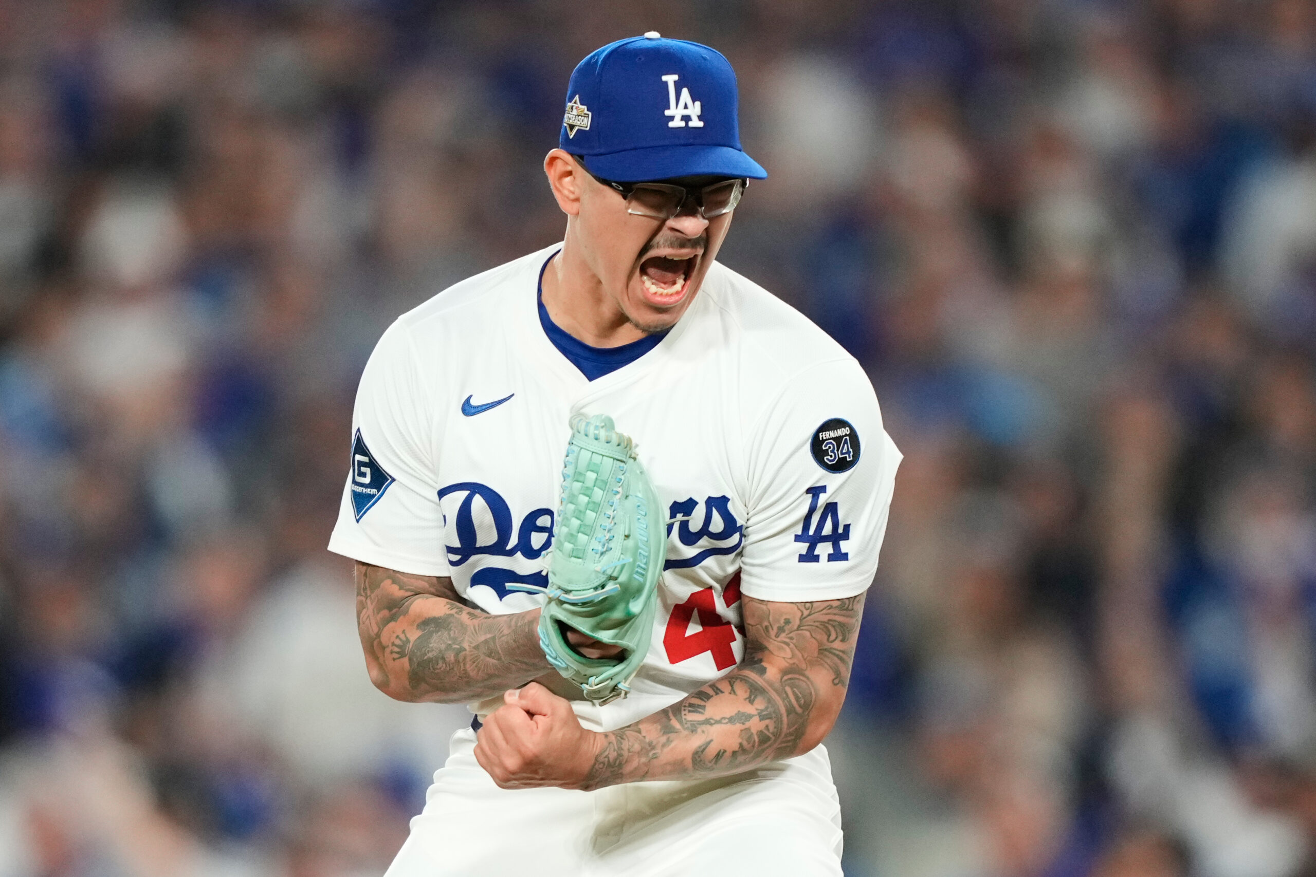Dodgers relief pitcher Anthony Banda celebrates after striking out the...