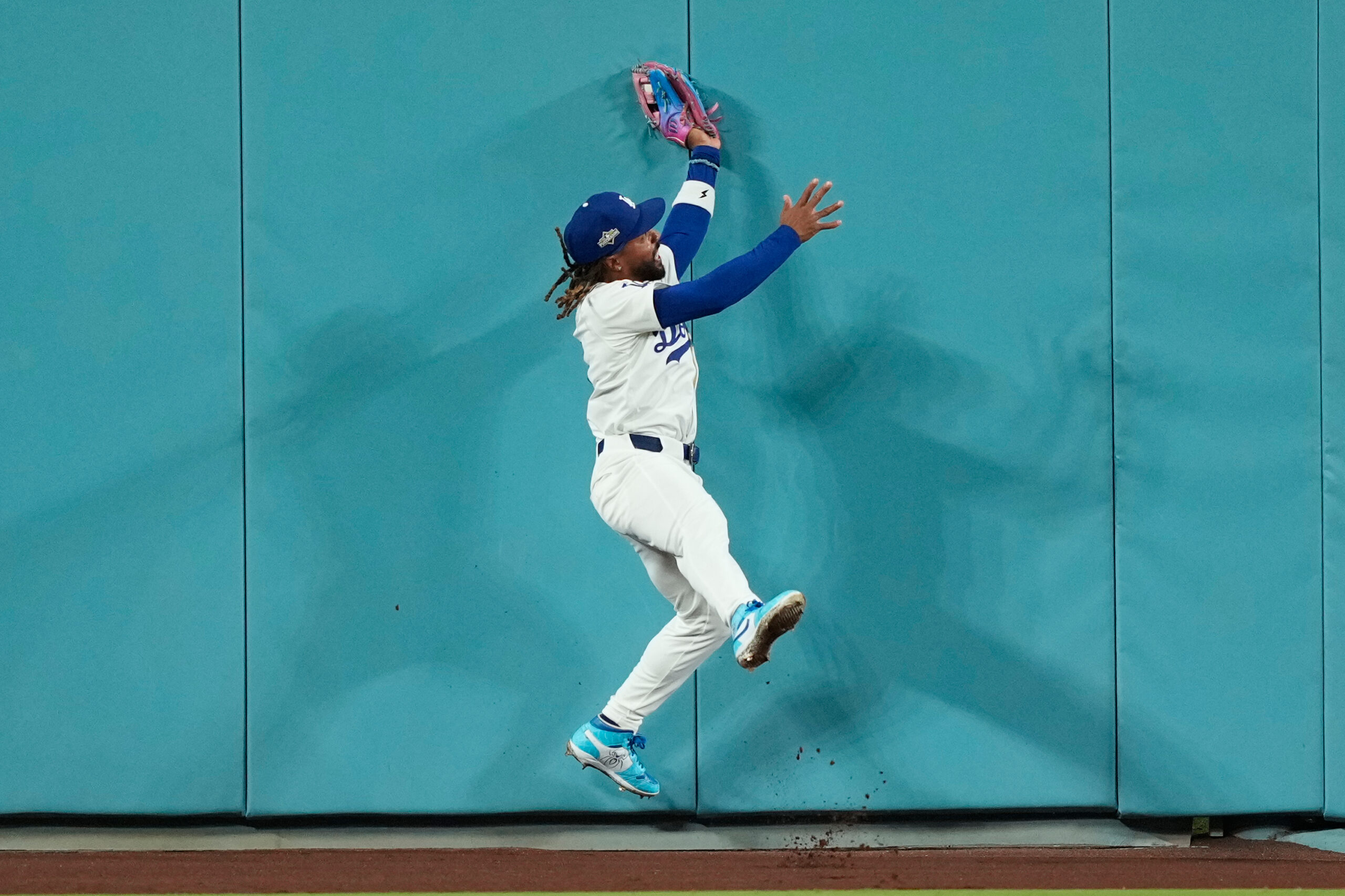 Dodgers center fielder Justin Dean makes a leaping catch against...