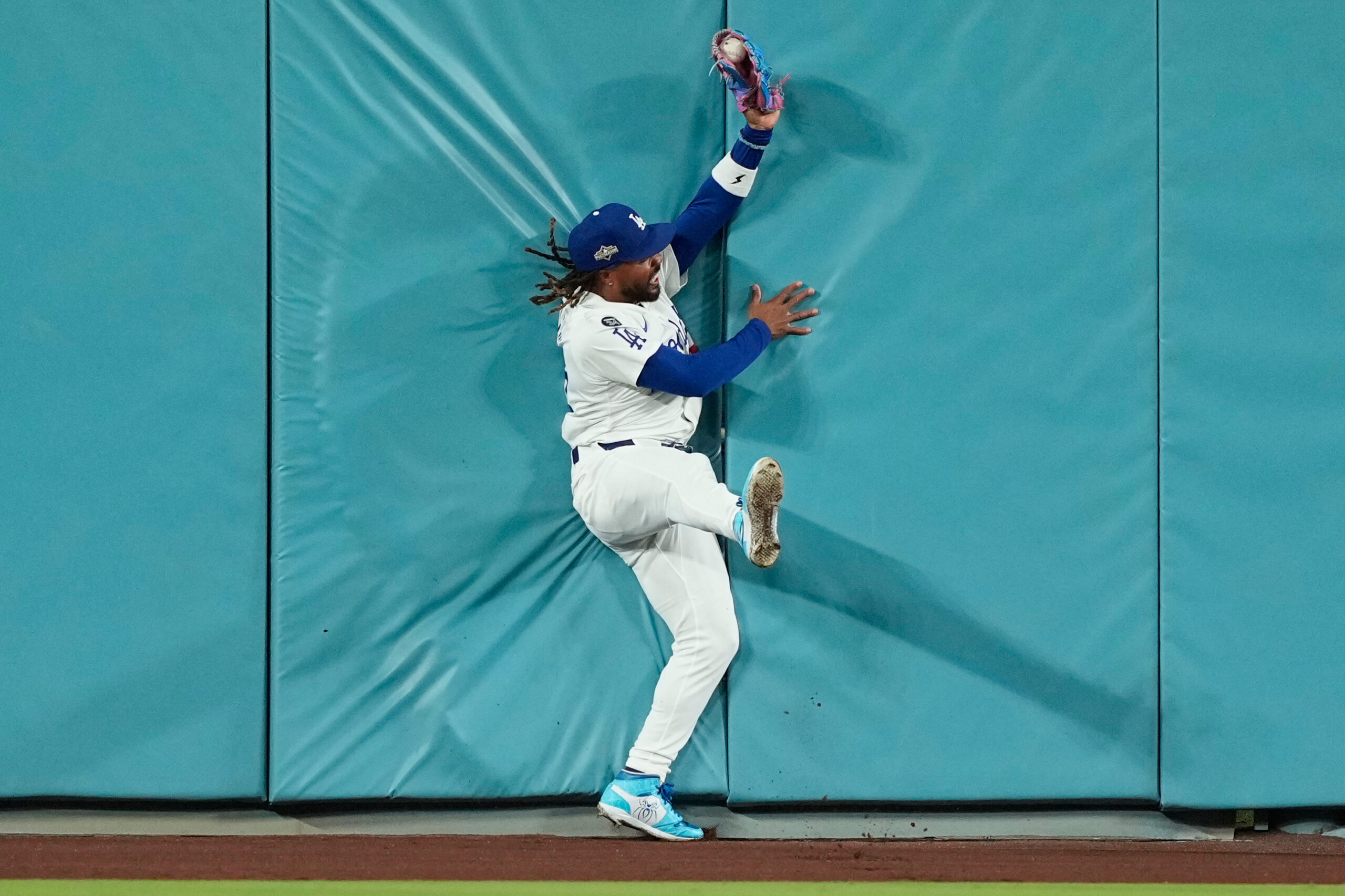 Dodgers center fielder Justin Dean makes a leaping catch against...