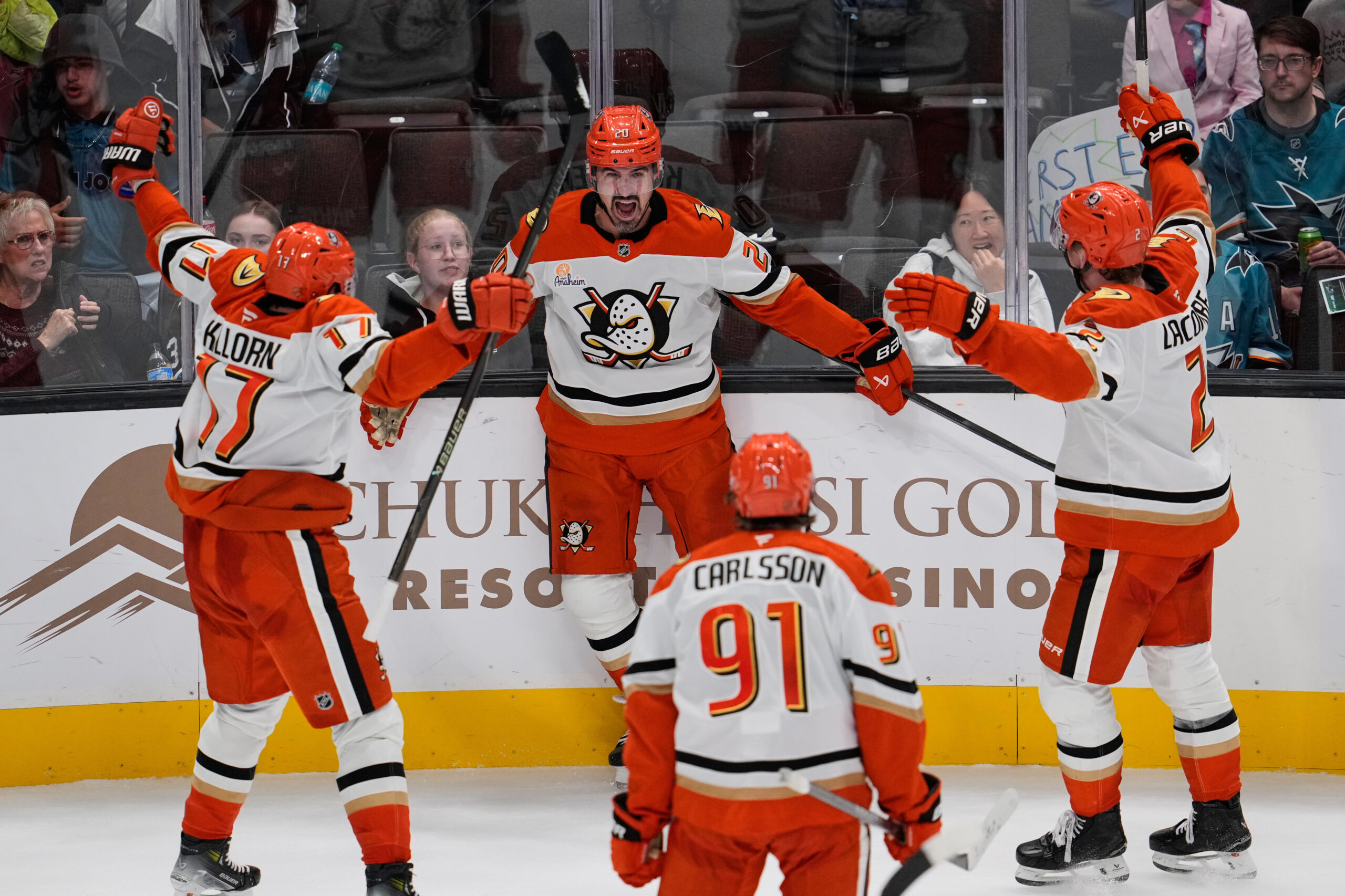 Ducks left wing Chris Kreider, center, celebrates with teammates after...