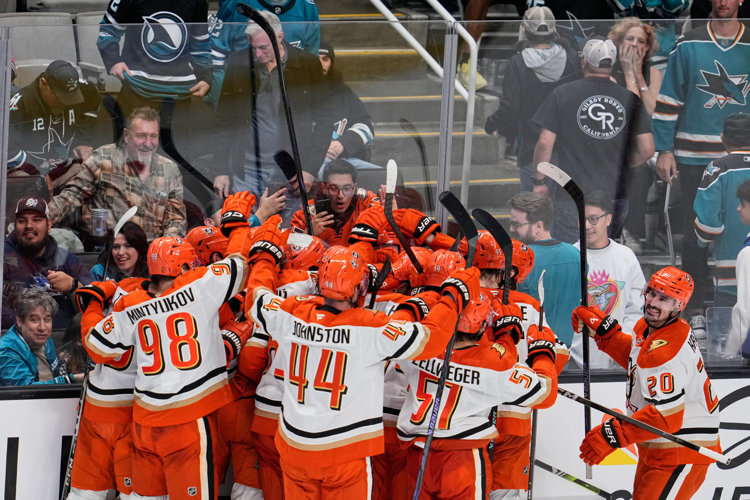 Ducks center Leo Carlsson is mobbed by teammates after scoring...