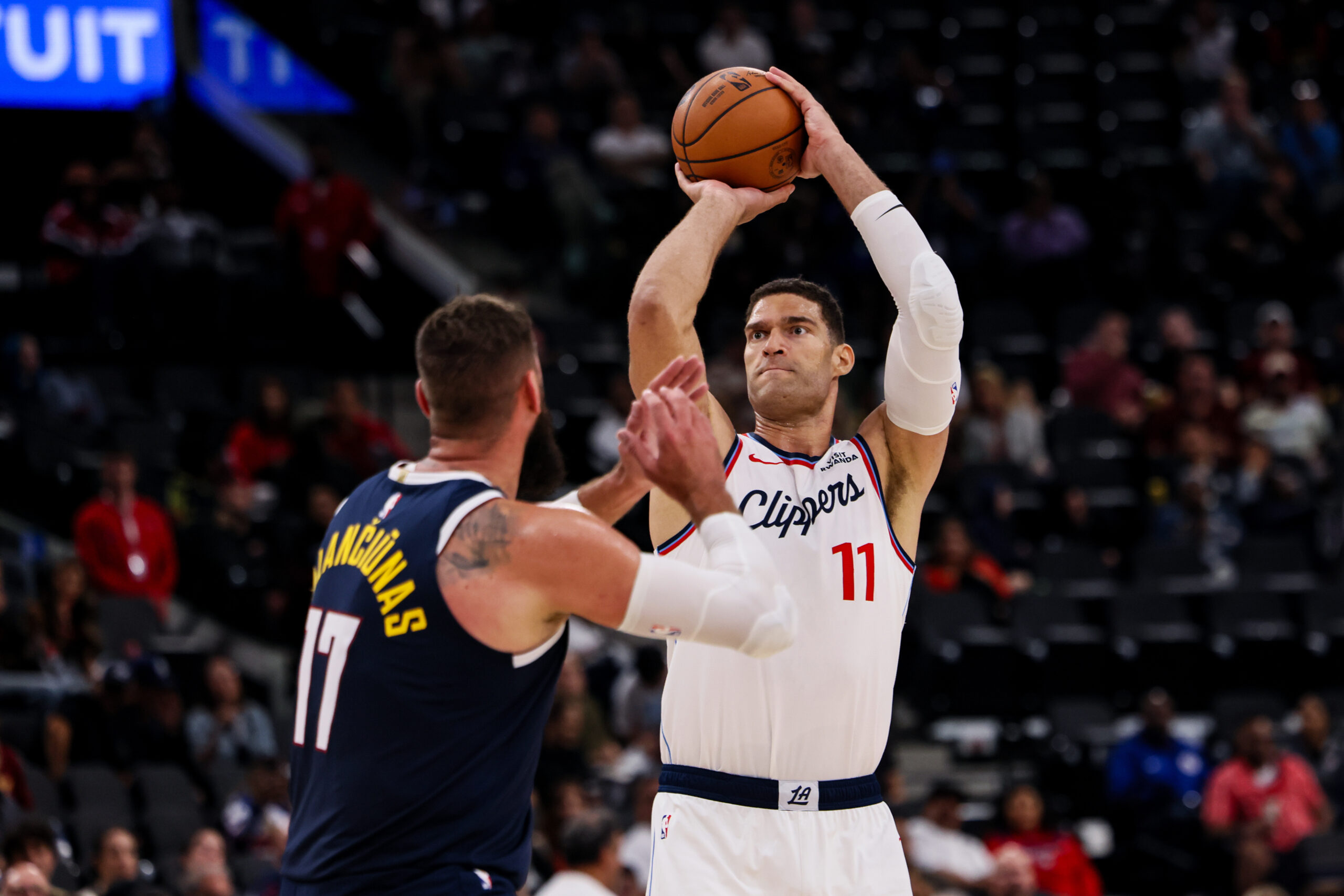 Clippers center Brook Lopez, right, attempts to score against Denver...