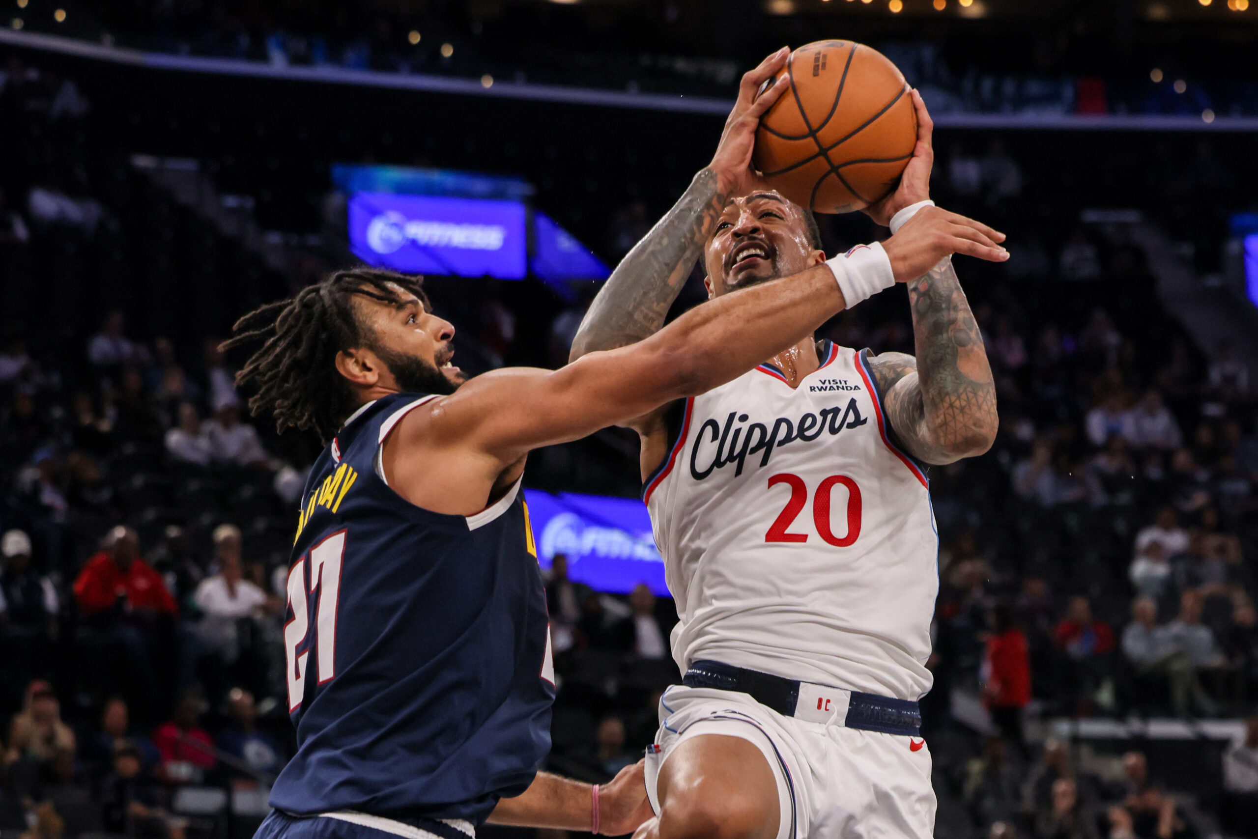 Denver Nuggets guard Jamal Murray, left, blocks Clippers forward-center John...