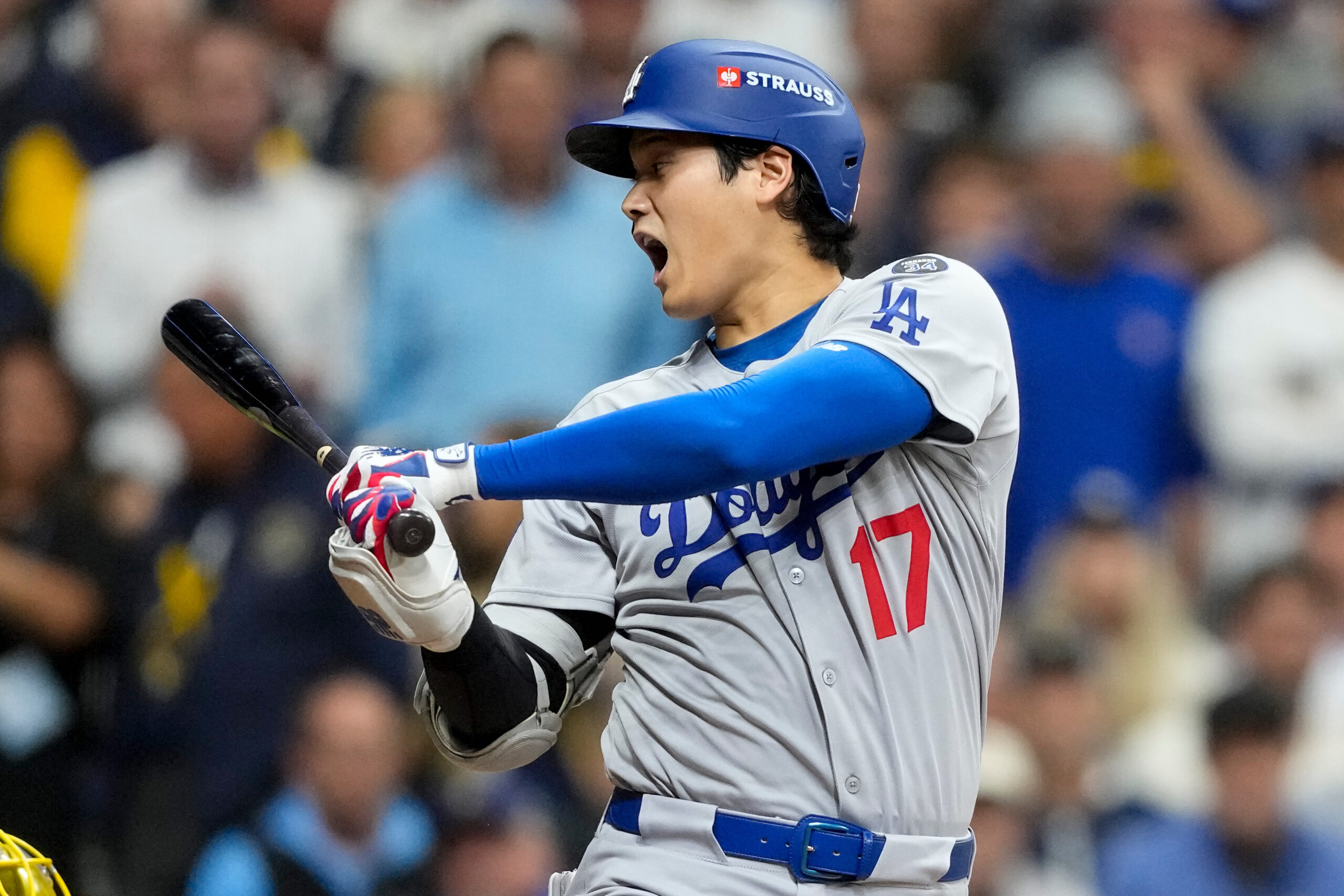 Dodgers two-way player Shohei Ohtani reacts during the first inning...