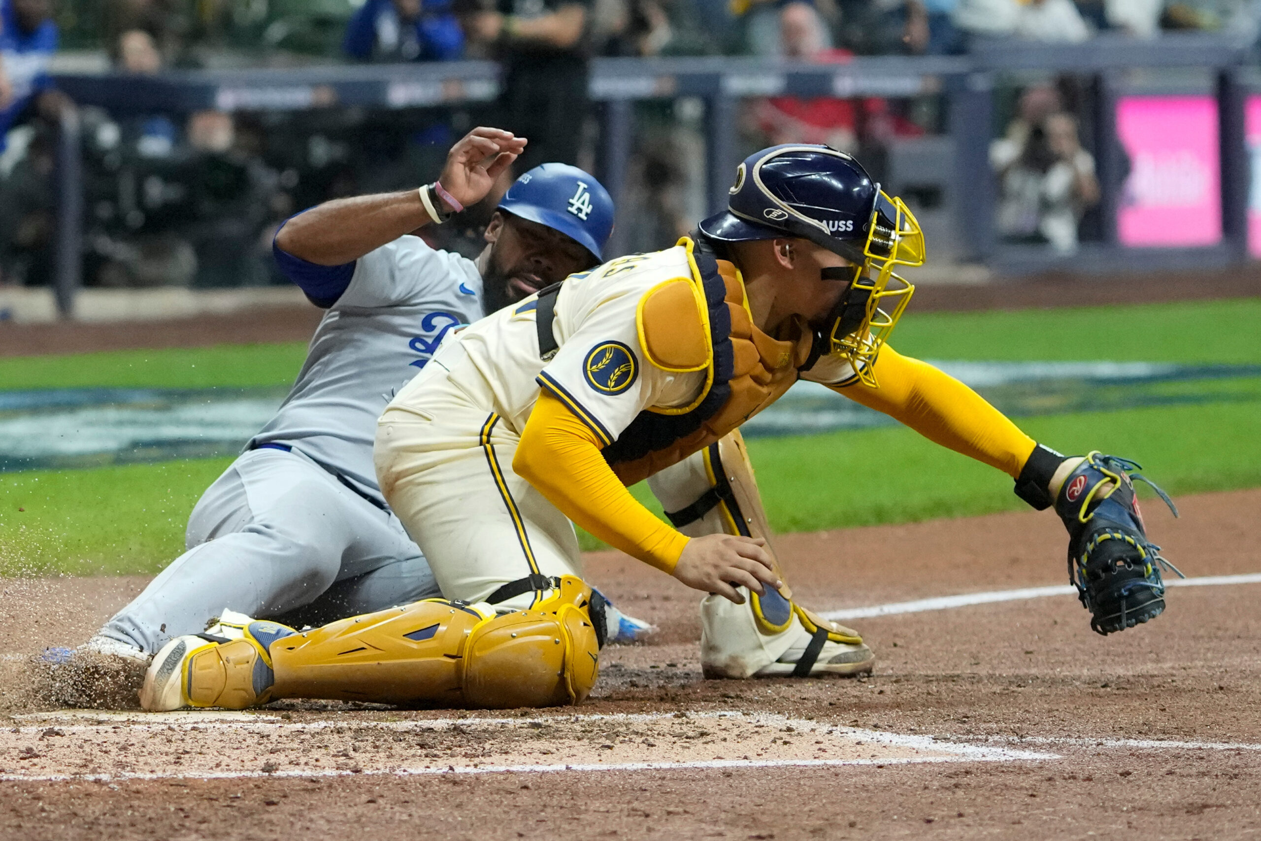 The Dodgers’ Teoscar Hernández, left, is forced out at home...