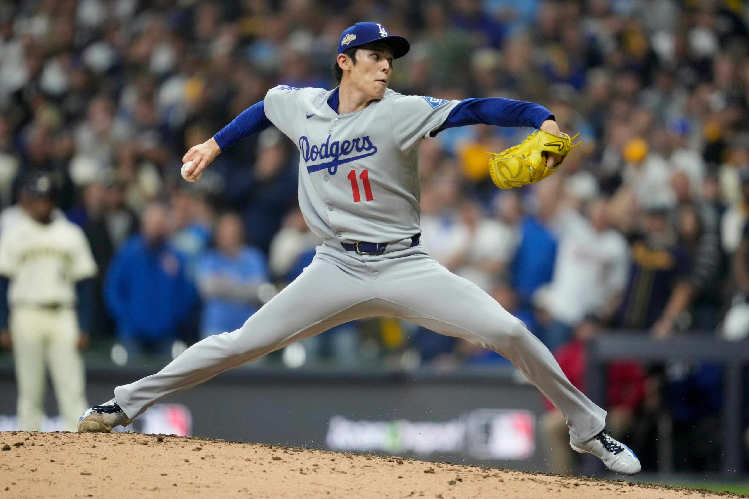 Dodgers relief pitcher Roki Sasaki throws to the plate against...