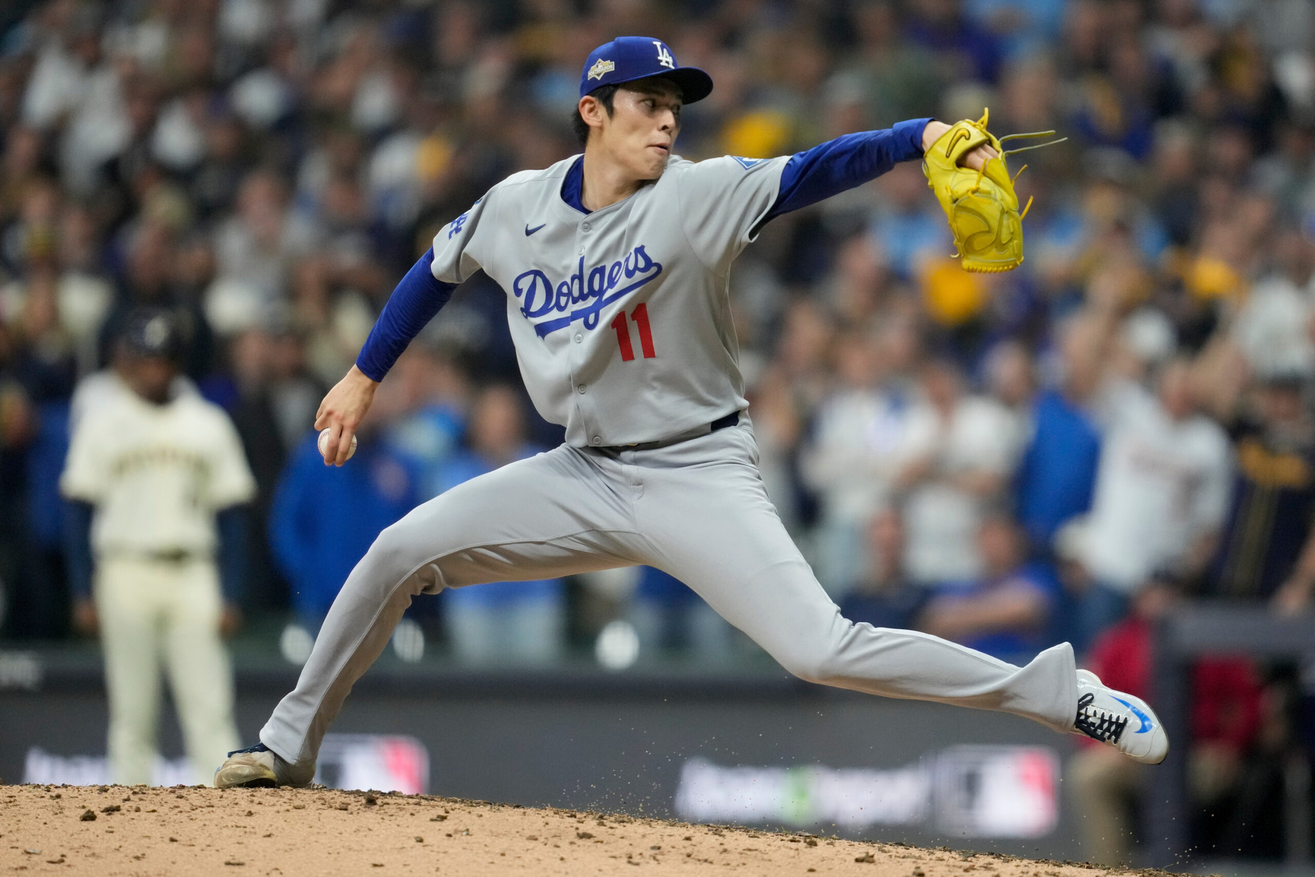 Dodgers relief pitcher Roki Sasaki throws to the plate against...