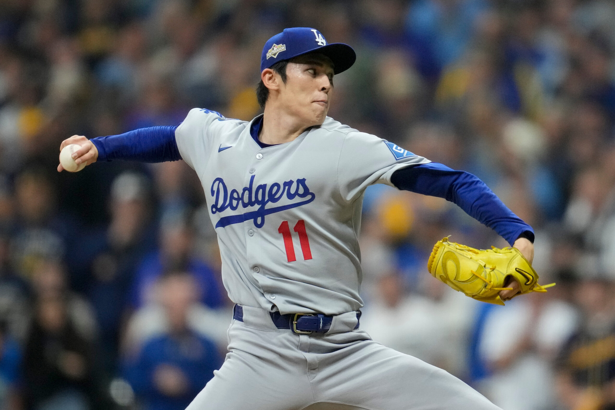 Dodgers relief pitcher Roki Sasaki throws to the plate against...