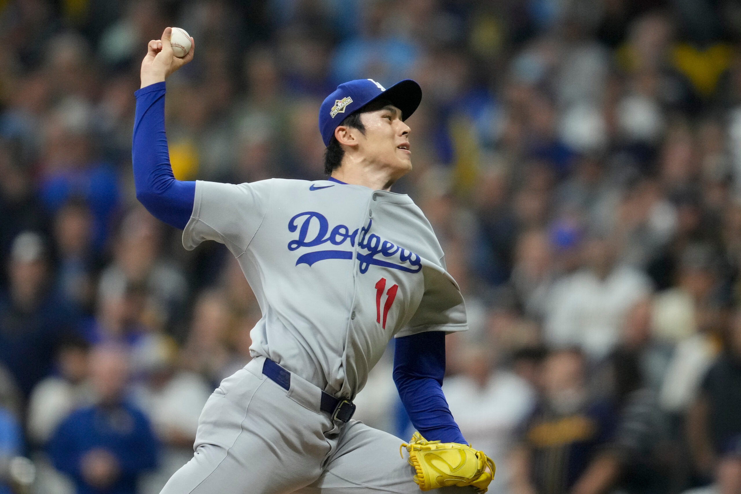 Dodgers relief pitcher Roki Sasaki throws to the plate against...