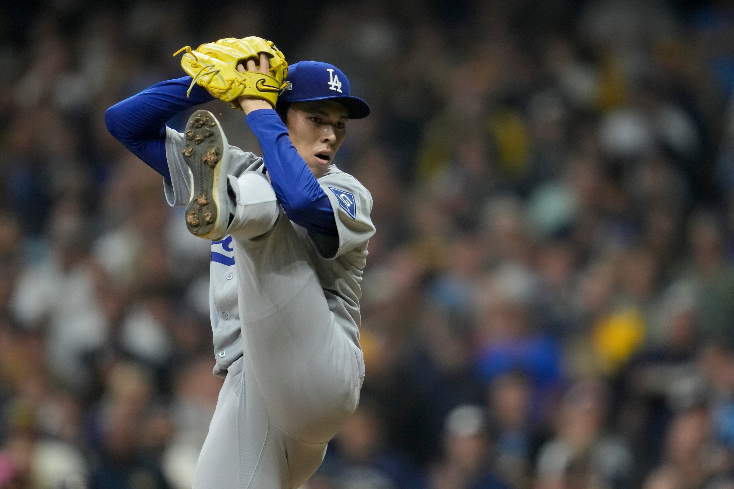 Dodgers relief pitcher Roki Sasaki throws to the plate against...