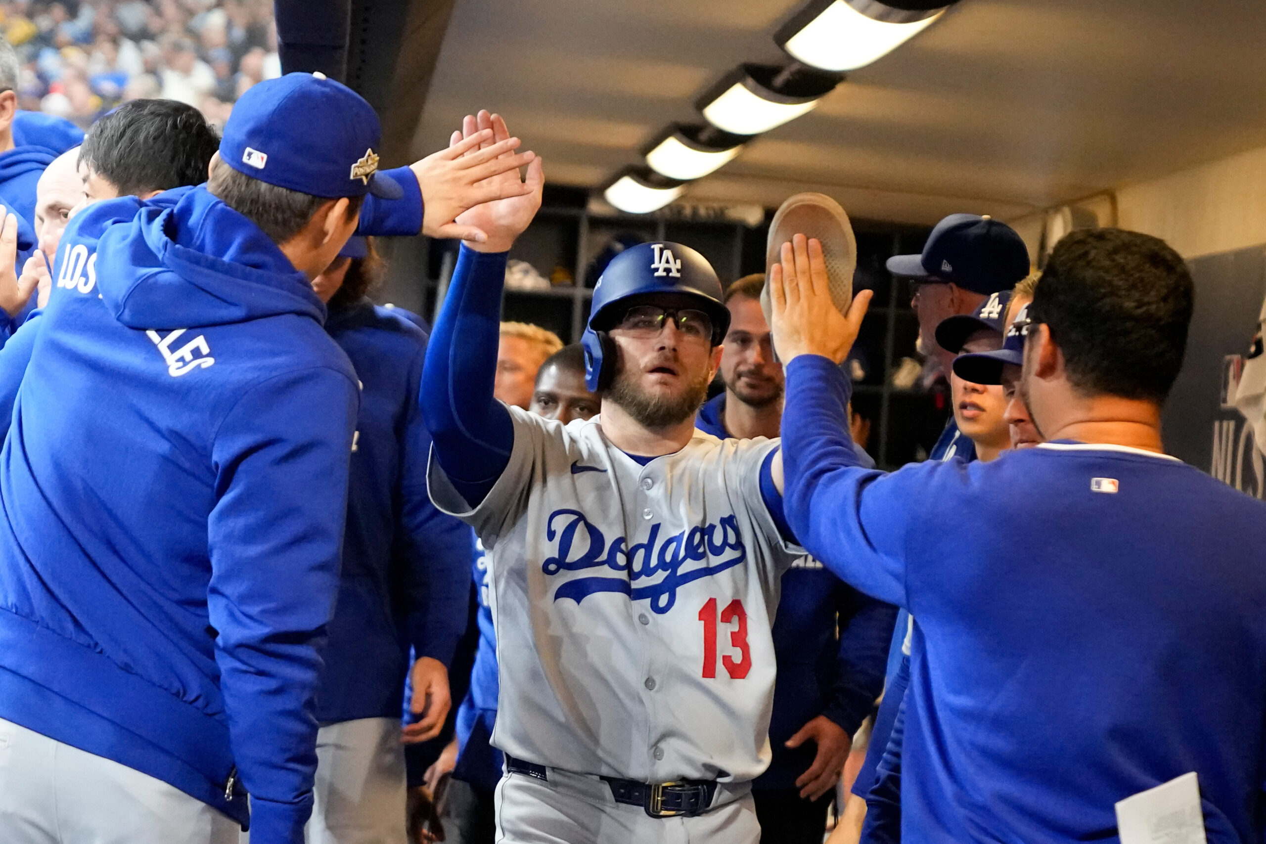The Dodgers’ Max Muncy celebrates after scoring on a bases-loaded...