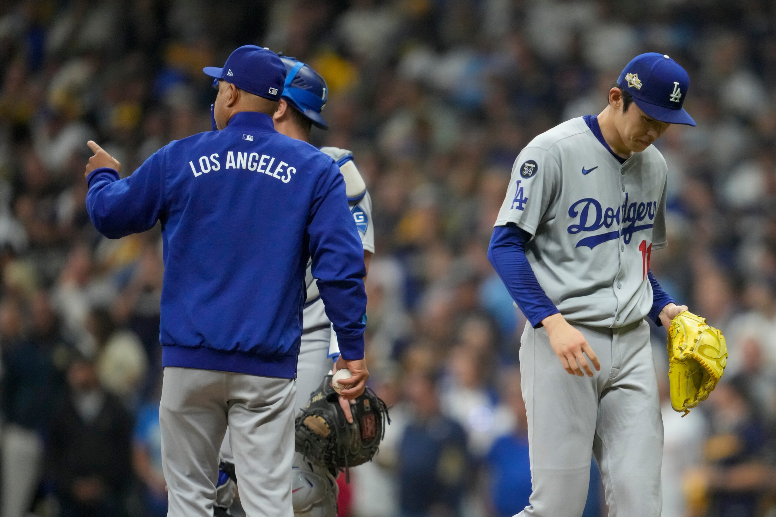 Dodgers relief pitcher Roki Sasaki is taken out of the...