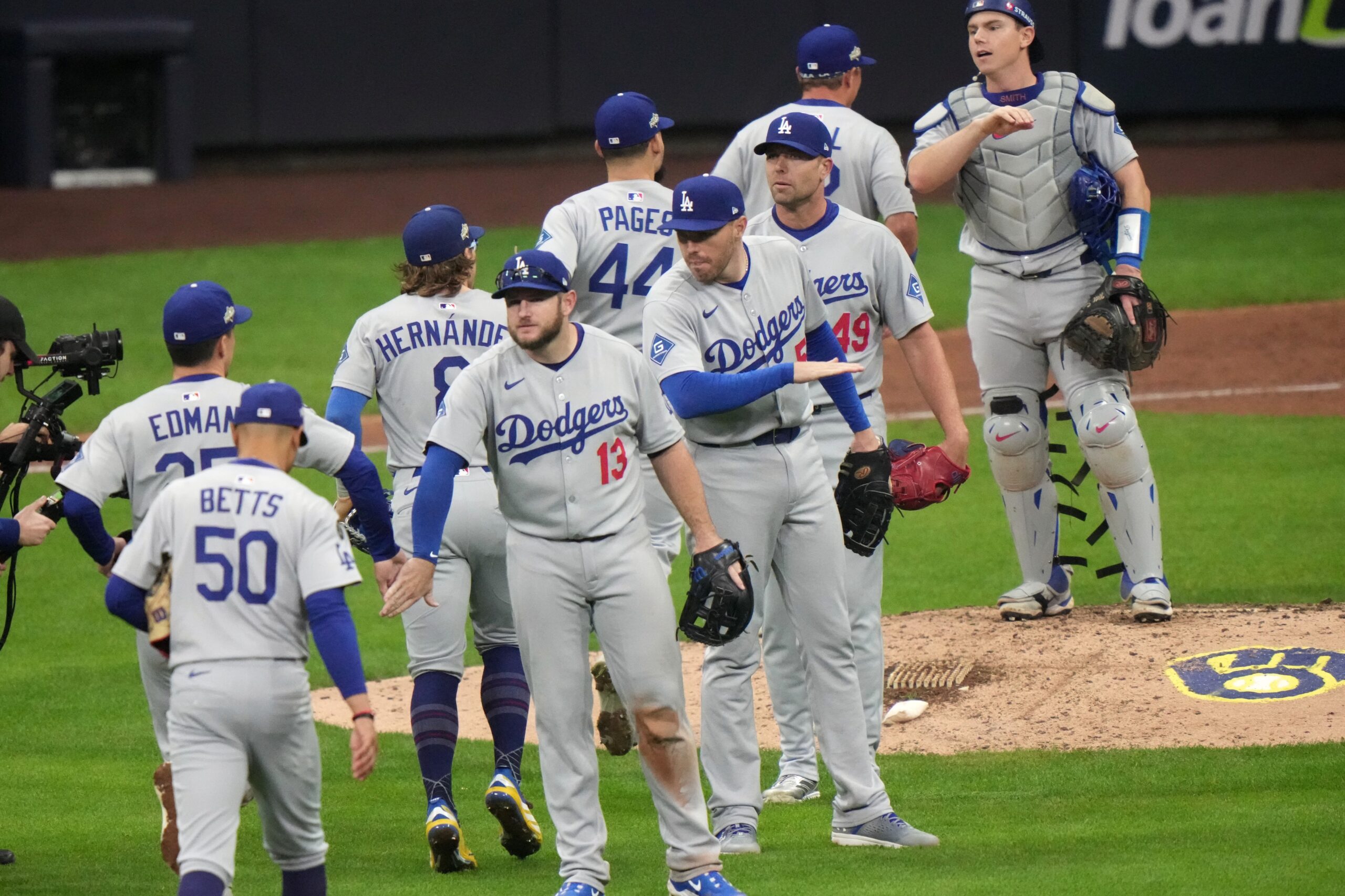 The Dodgers celebrate after their 2-1 win against the Milwaukee...