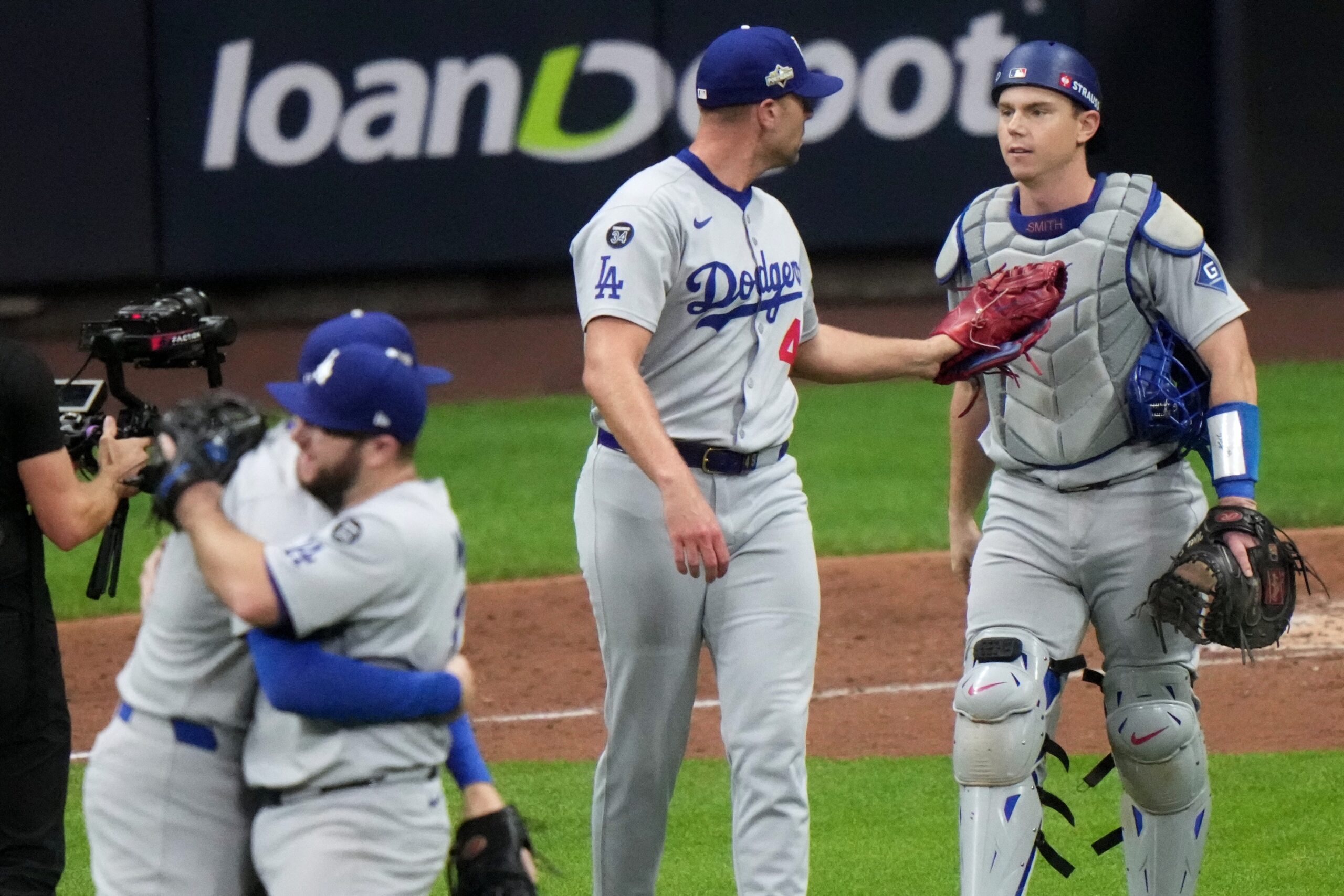 Dodgers relief pitcher Blake Treinen, center, and catcher Will Smith...