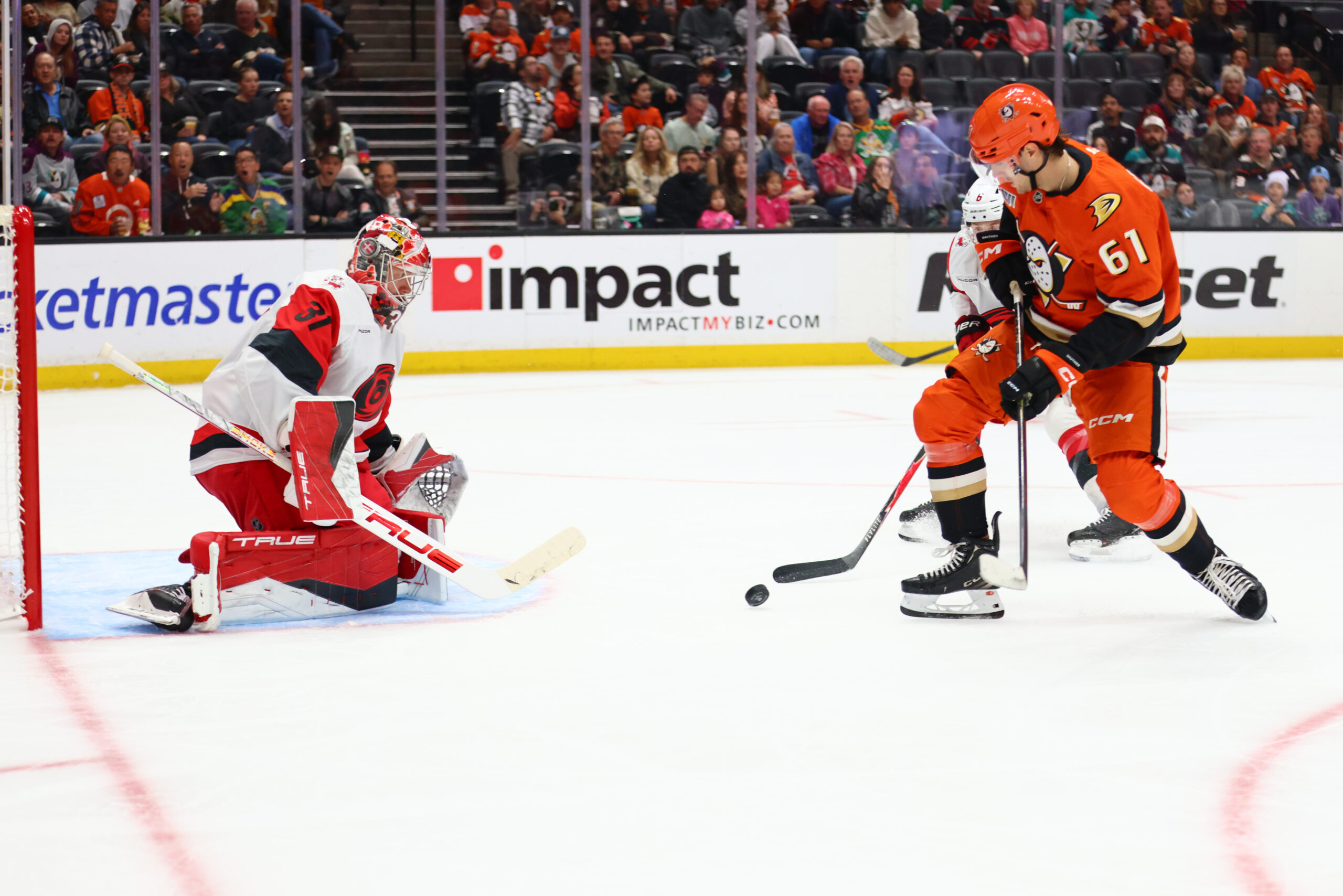 Carolina Hurricanes goaltender Frederik Andersen, left, and defenseman Mike Reilly...