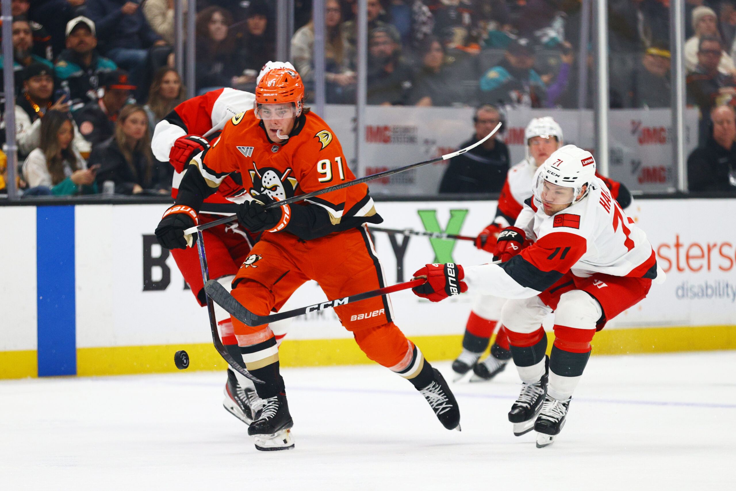 Ducks center Leo Carlsson, left, battles for control of the...