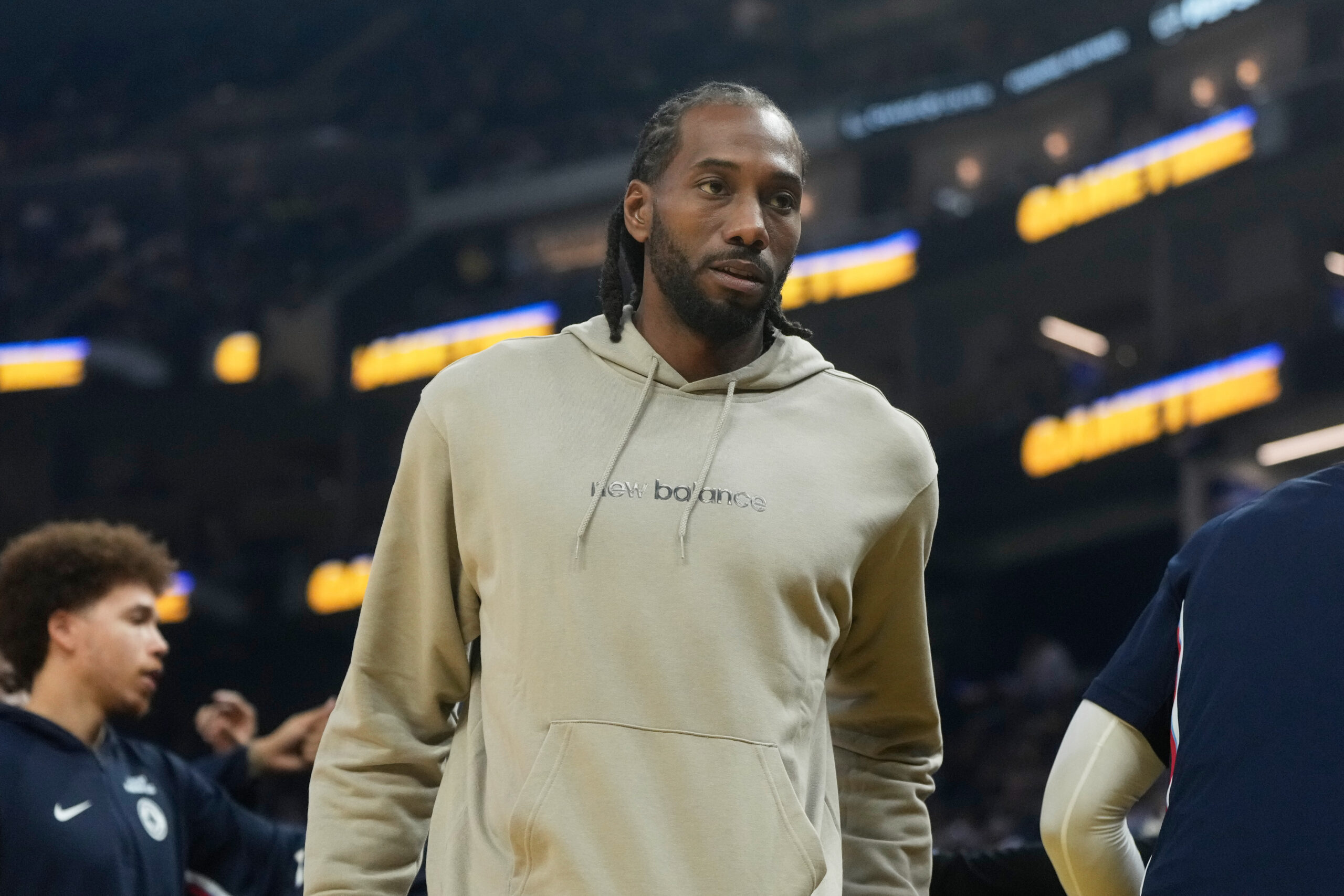 Clippers forward Kawhi Leonard walks toward the bench during the...