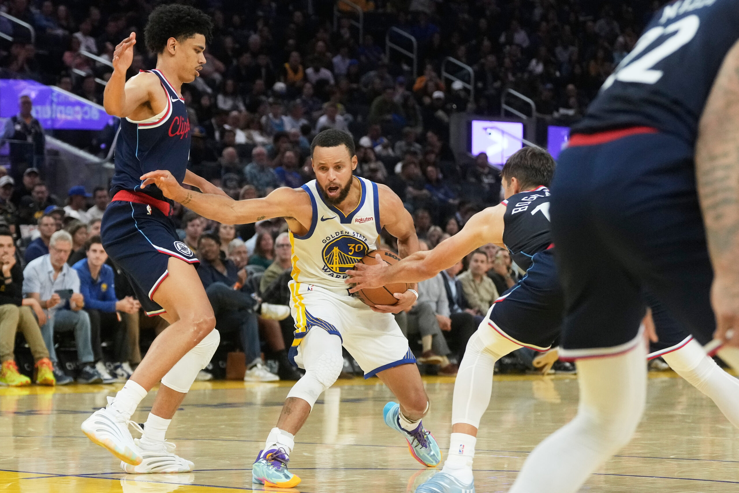 Golden State Warriors guard Steph Curry, middle, drives to the...