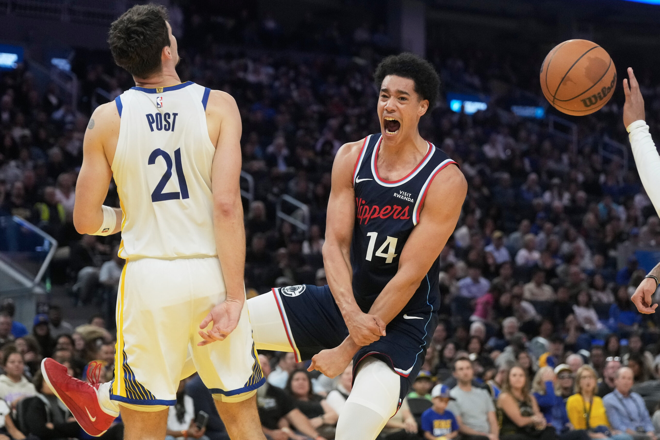 Clippers rookie center Yanic Konan Niederhauser (14) reacts after dunking...