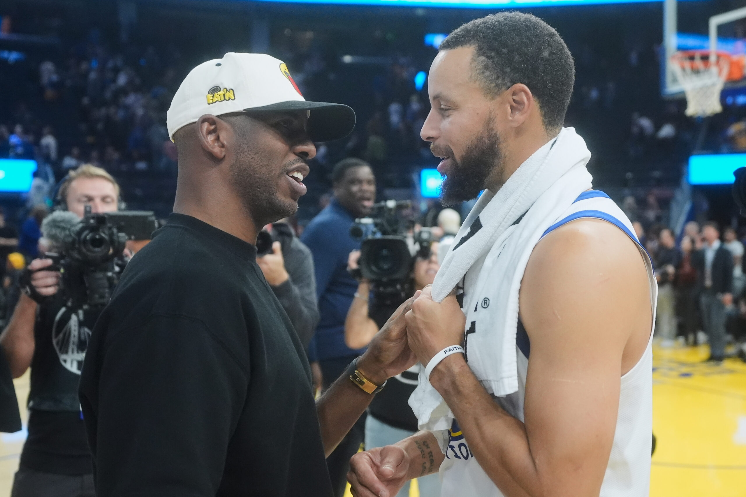 Clippers guard Chris Paul, left, talks with Golden State Warriors...