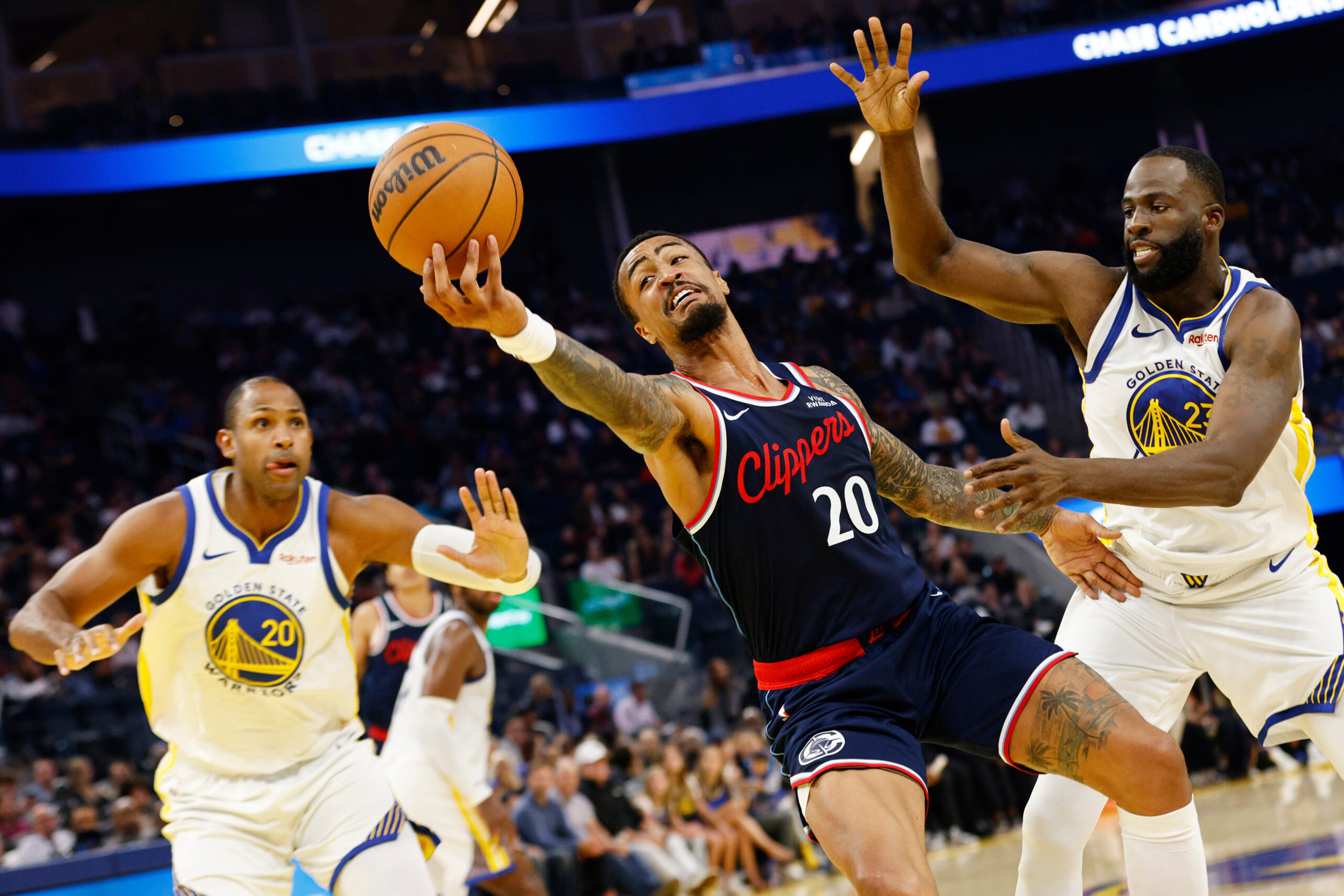 Clippers forward/center John Collins (20) grabs the pass as he...