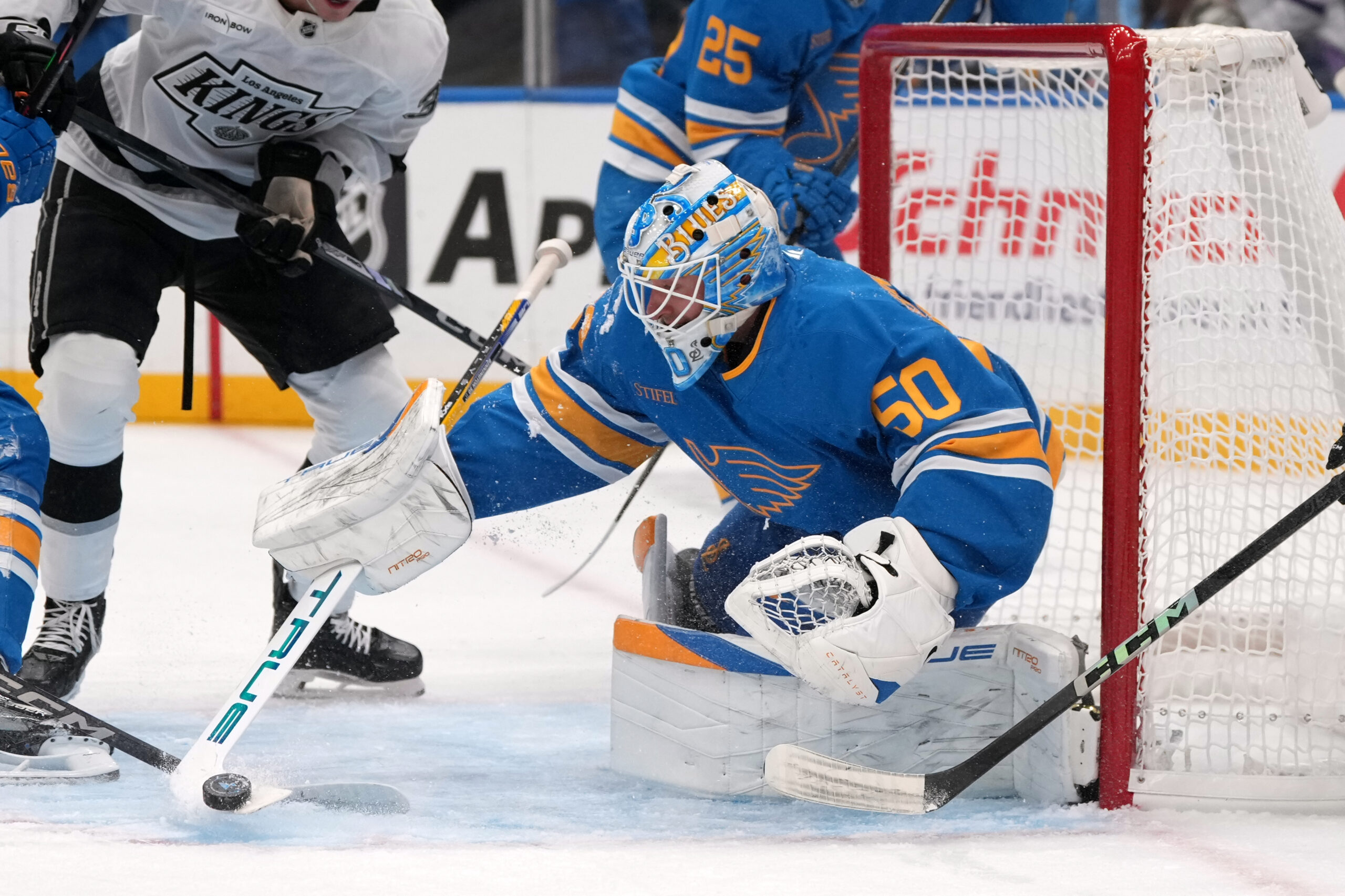 St. Louis Blues goaltender Jordan Binnington clears a puck during...