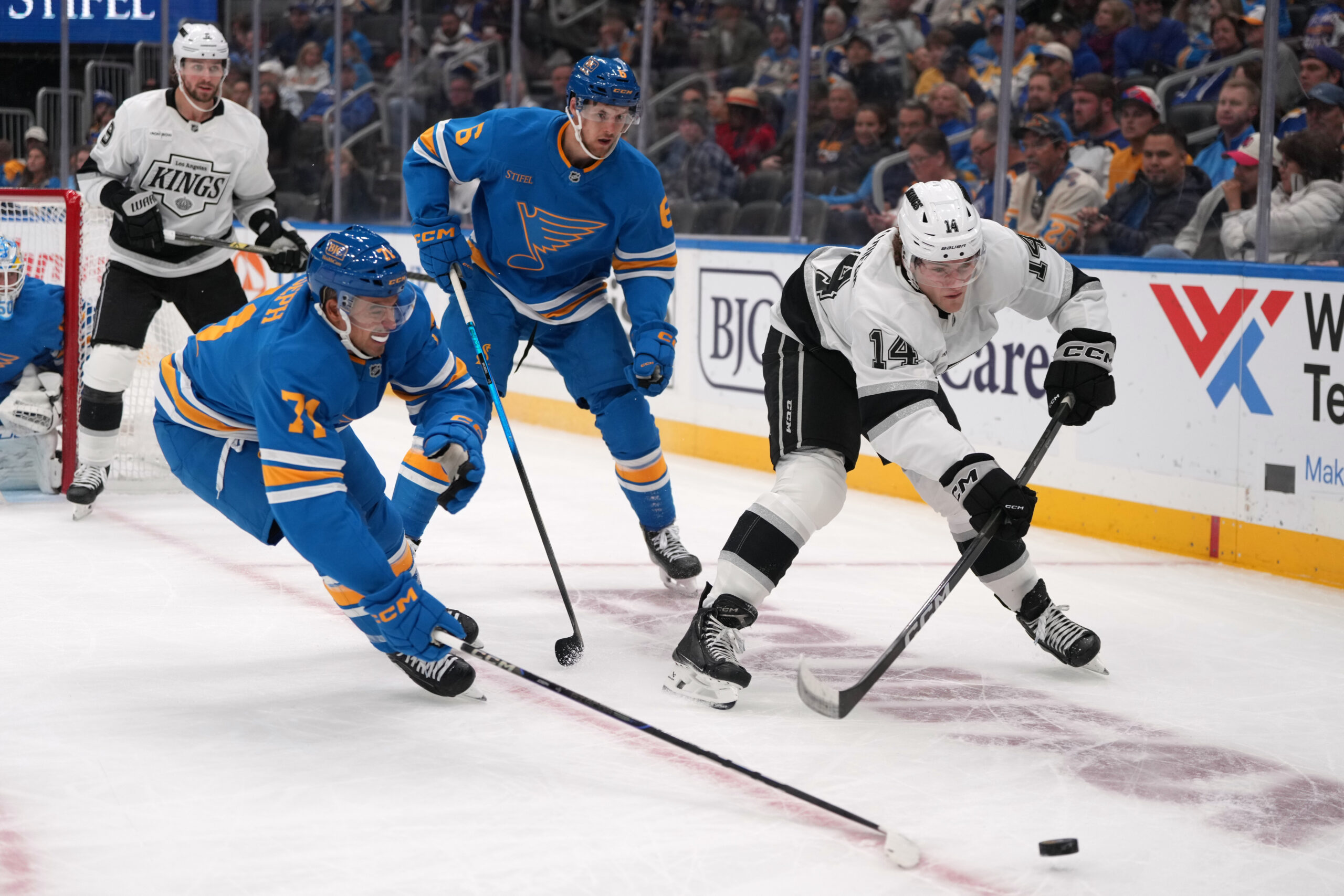 The Kings’ Alex Laferriere (14) passes as the St. Louis...