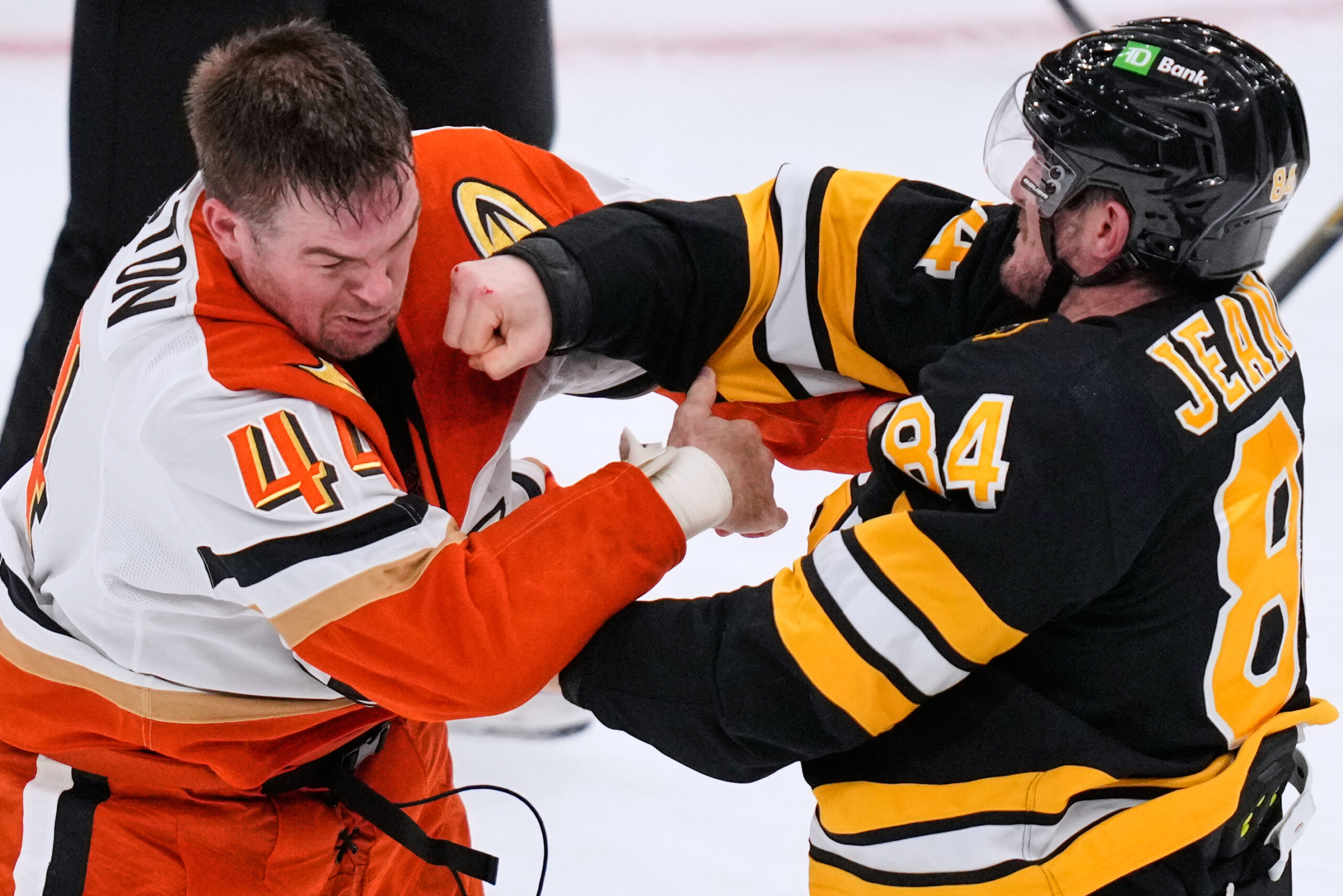 Boston Bruins left wing Tanner Jeannot (84) lands a punch...
