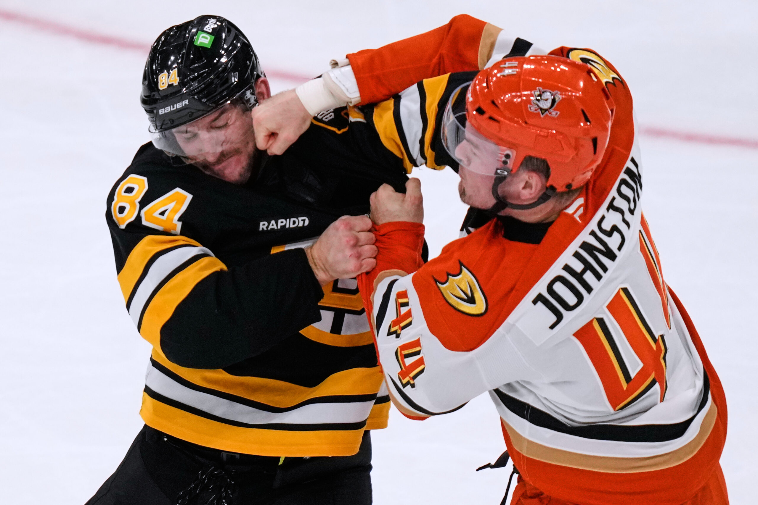 Ducks left wing Ross Johnston (44) lands a punch in...