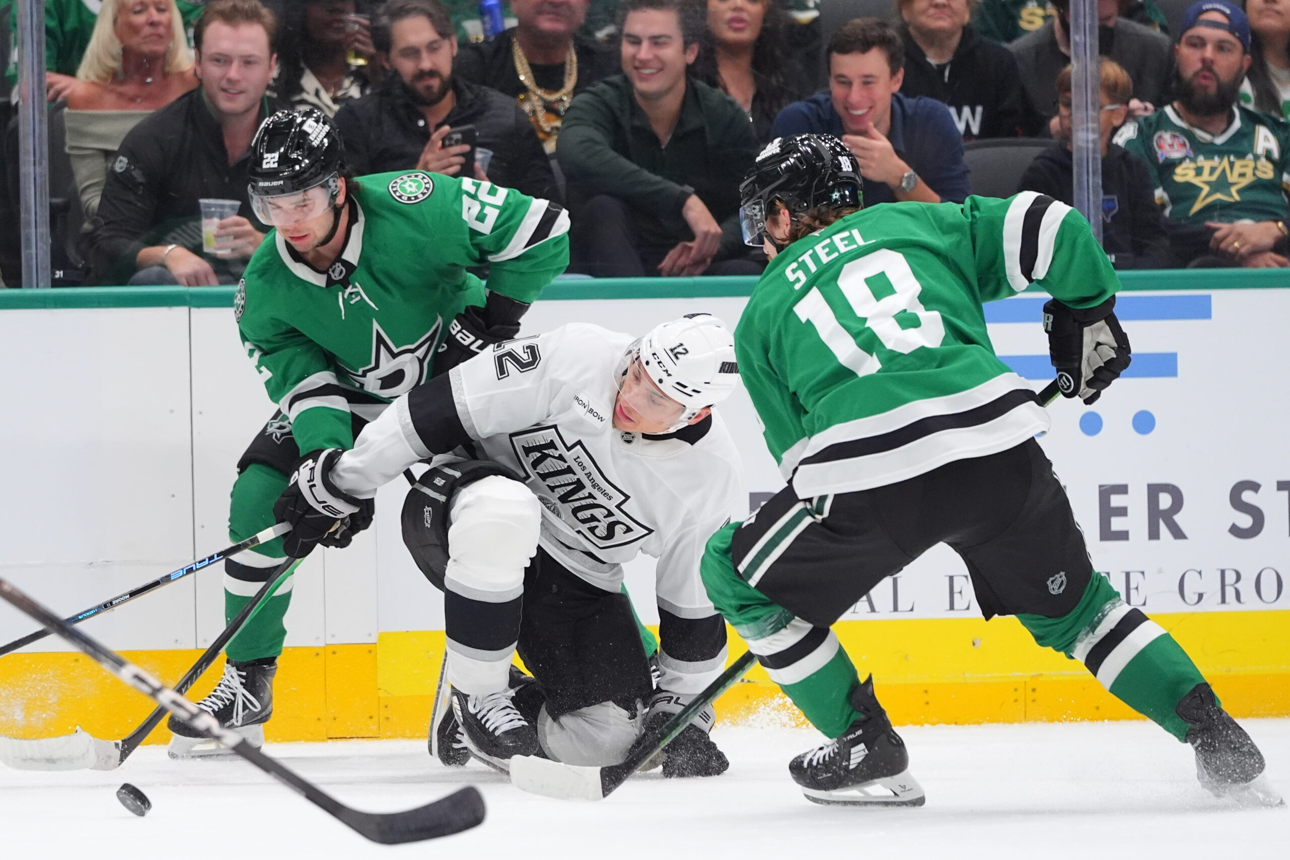 Kings left wing Trevor Moore (12) tries to control the...