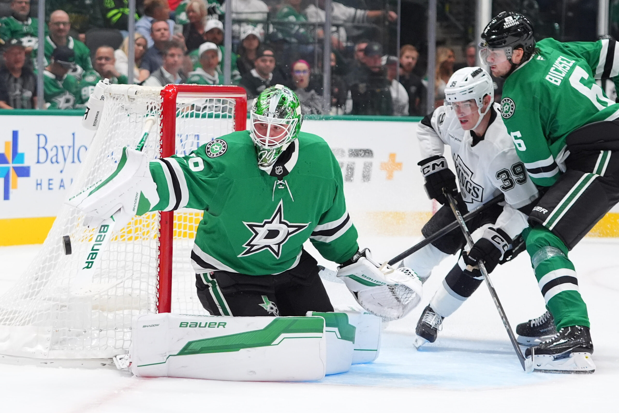 Dallas Stars goaltender Jake Oettinger (29) and Lian Bichsel (6)...