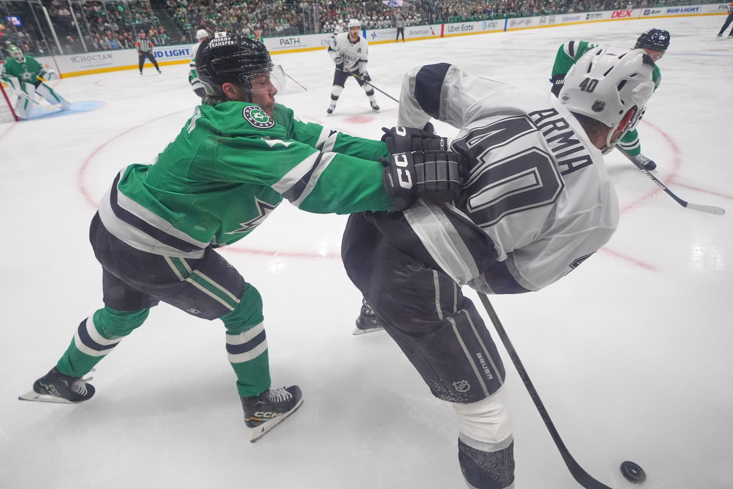 Dallas Stars defenseman Miro Heiskanen, left, pushes Kings right wing...