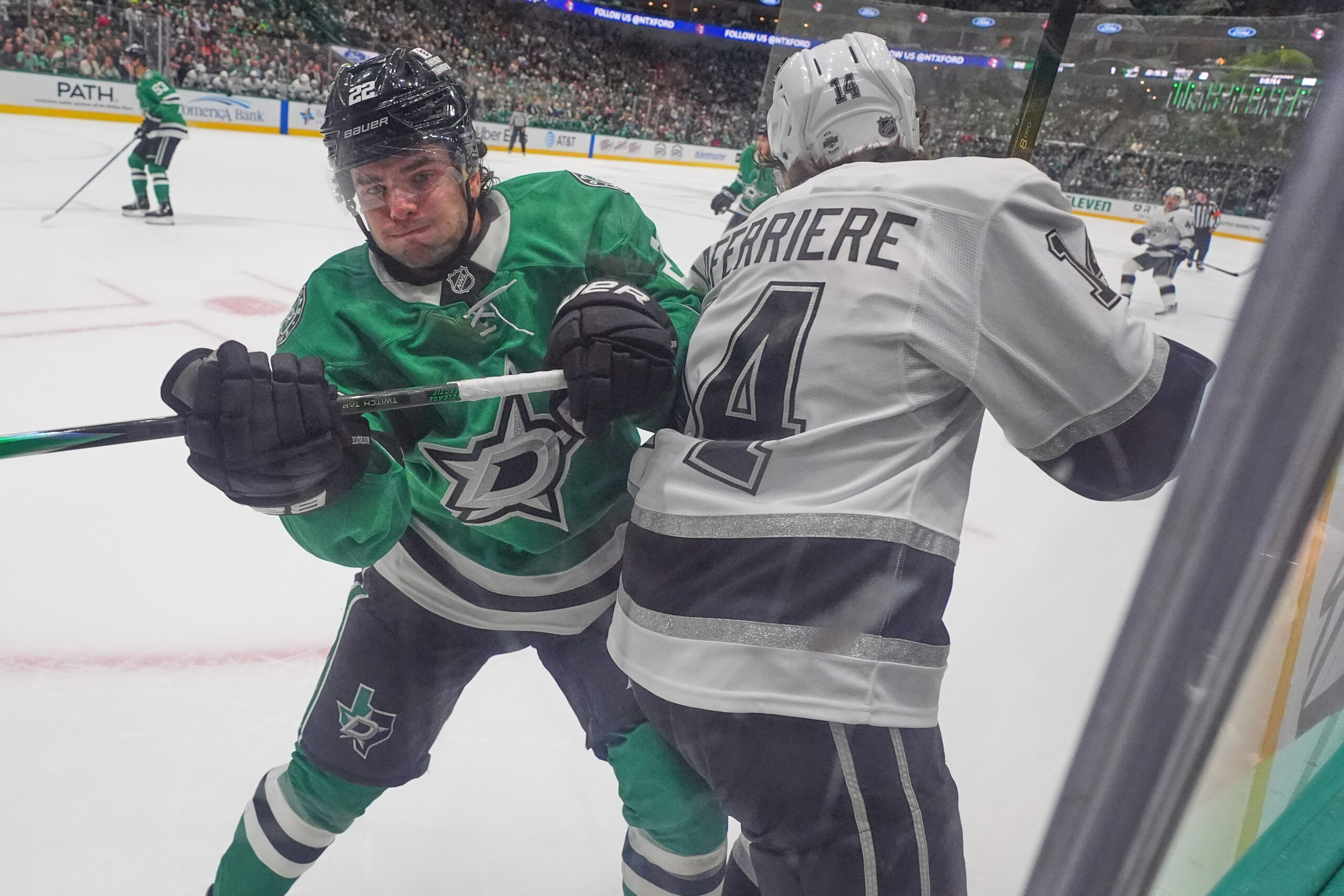 Dallas Stars defenseman Miro Heiskanen, left, pushes Kings right wing...