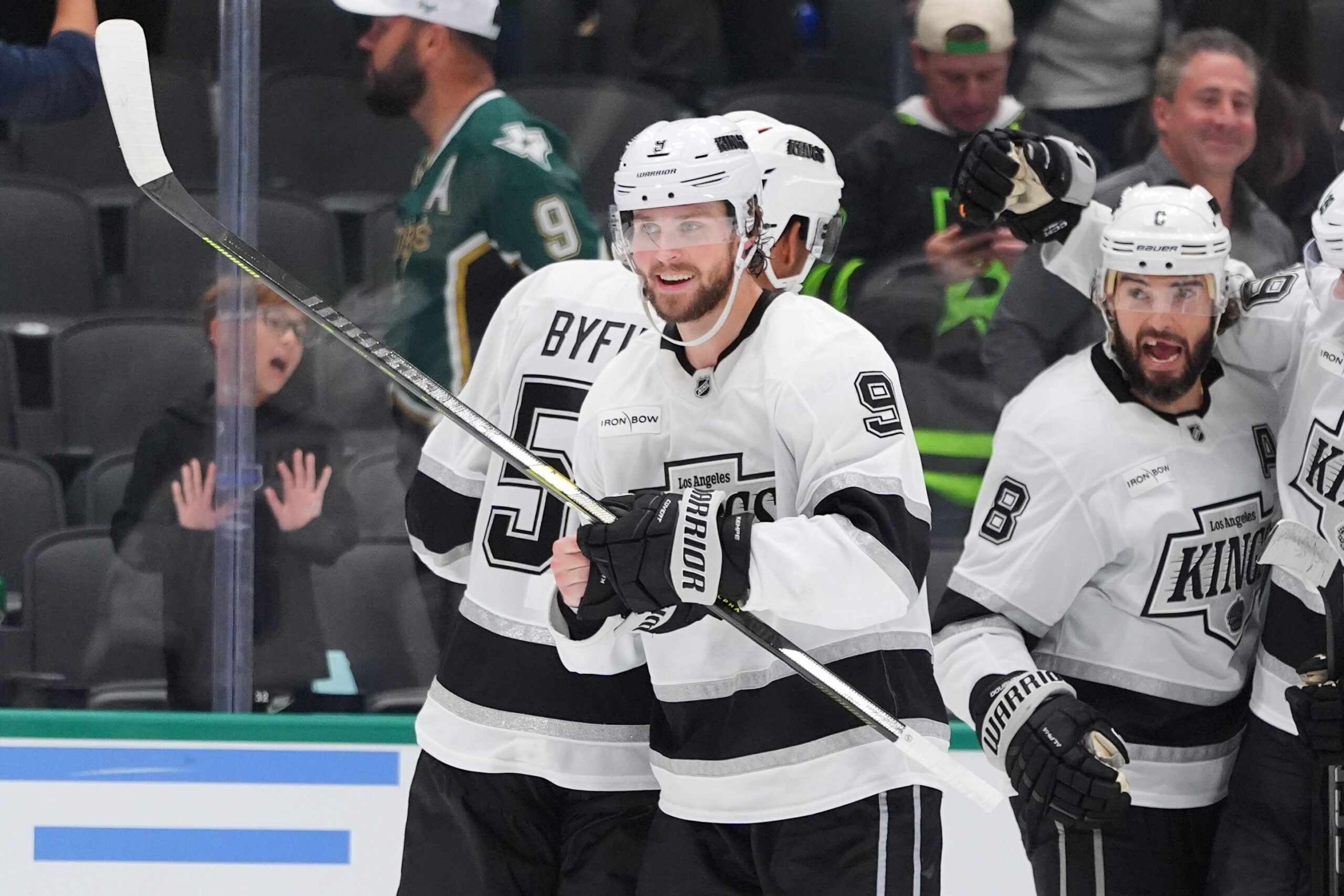 Kings right wing Adrian Kempe (9) smiles as his teammates...