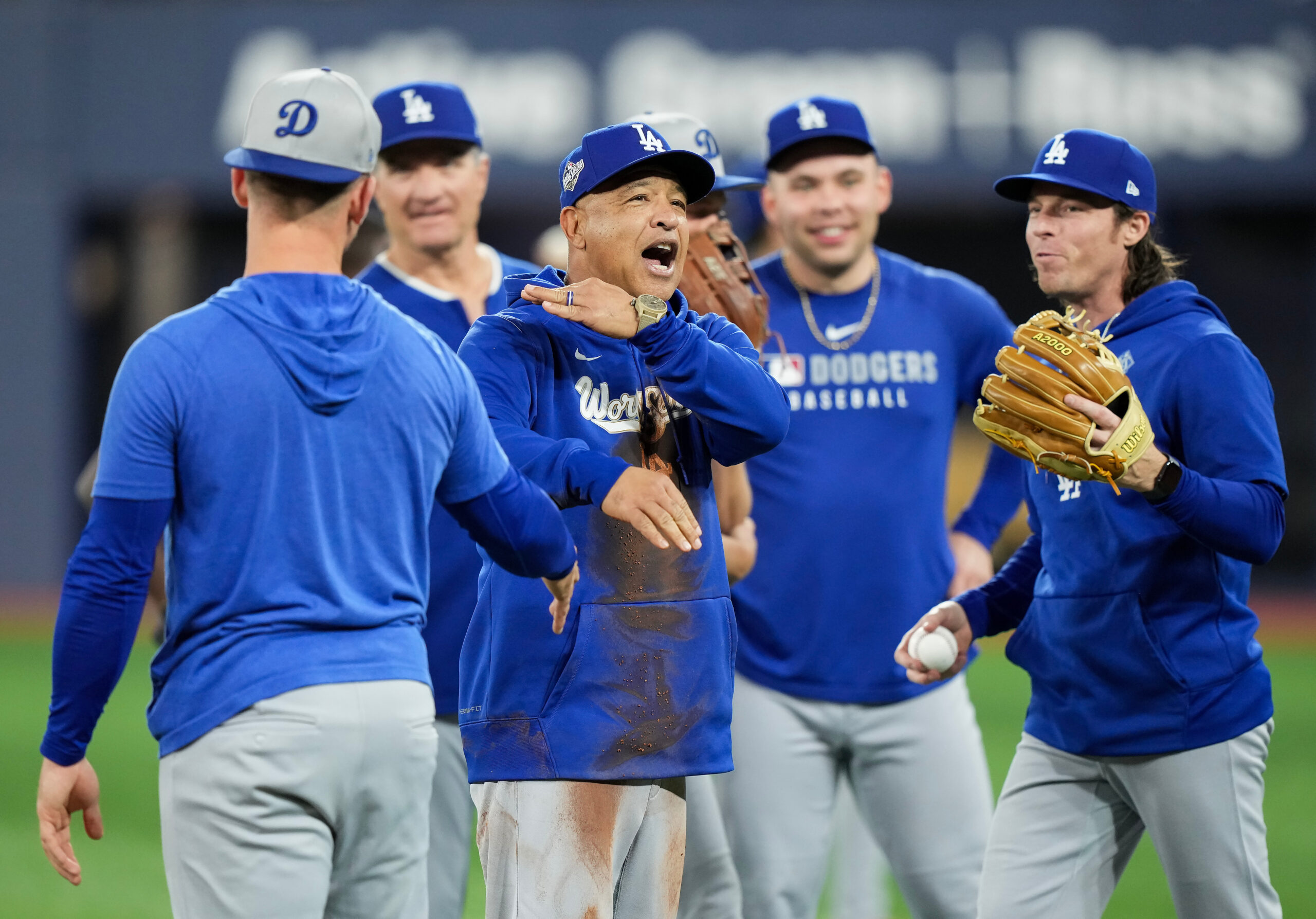 Dodgers manager Dave Roberts, center, laughs with his team after...