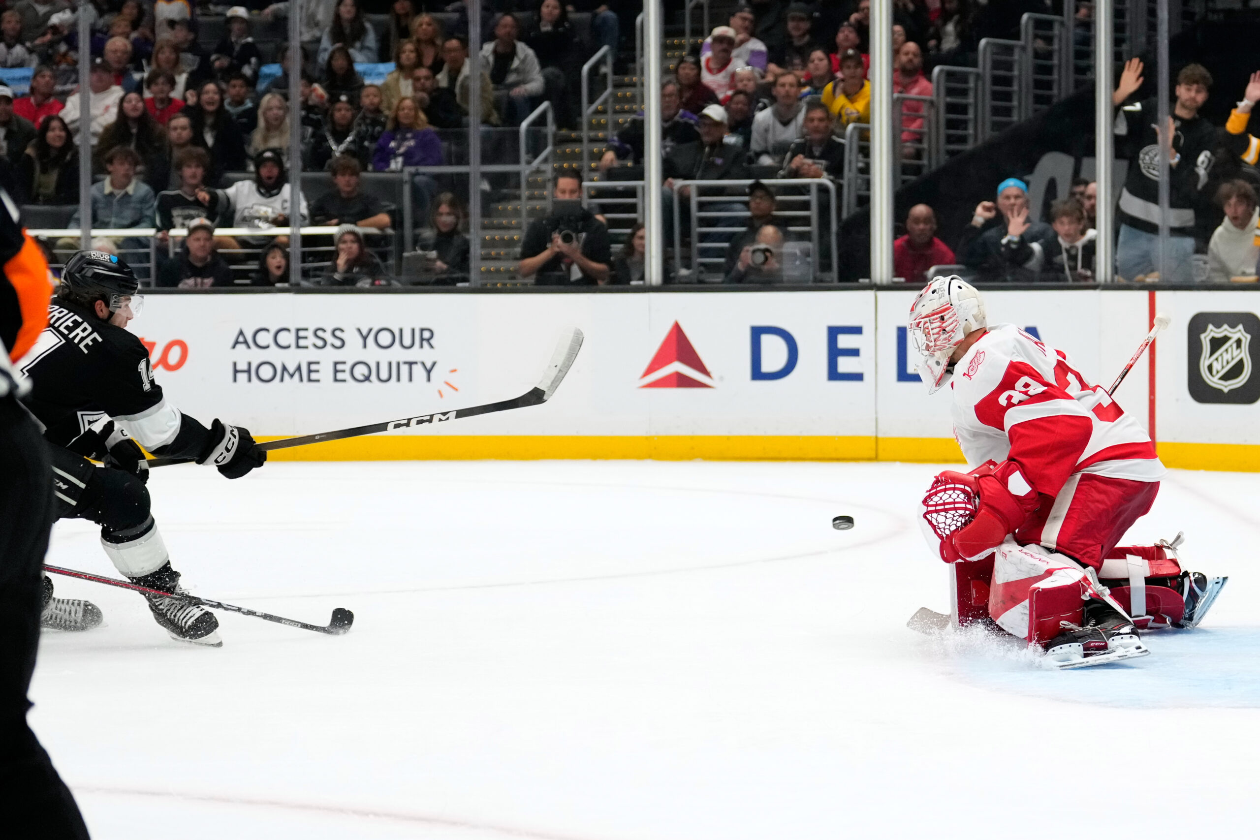 Kings right wing Alex Laferriere, left, scores on Detroit Red...