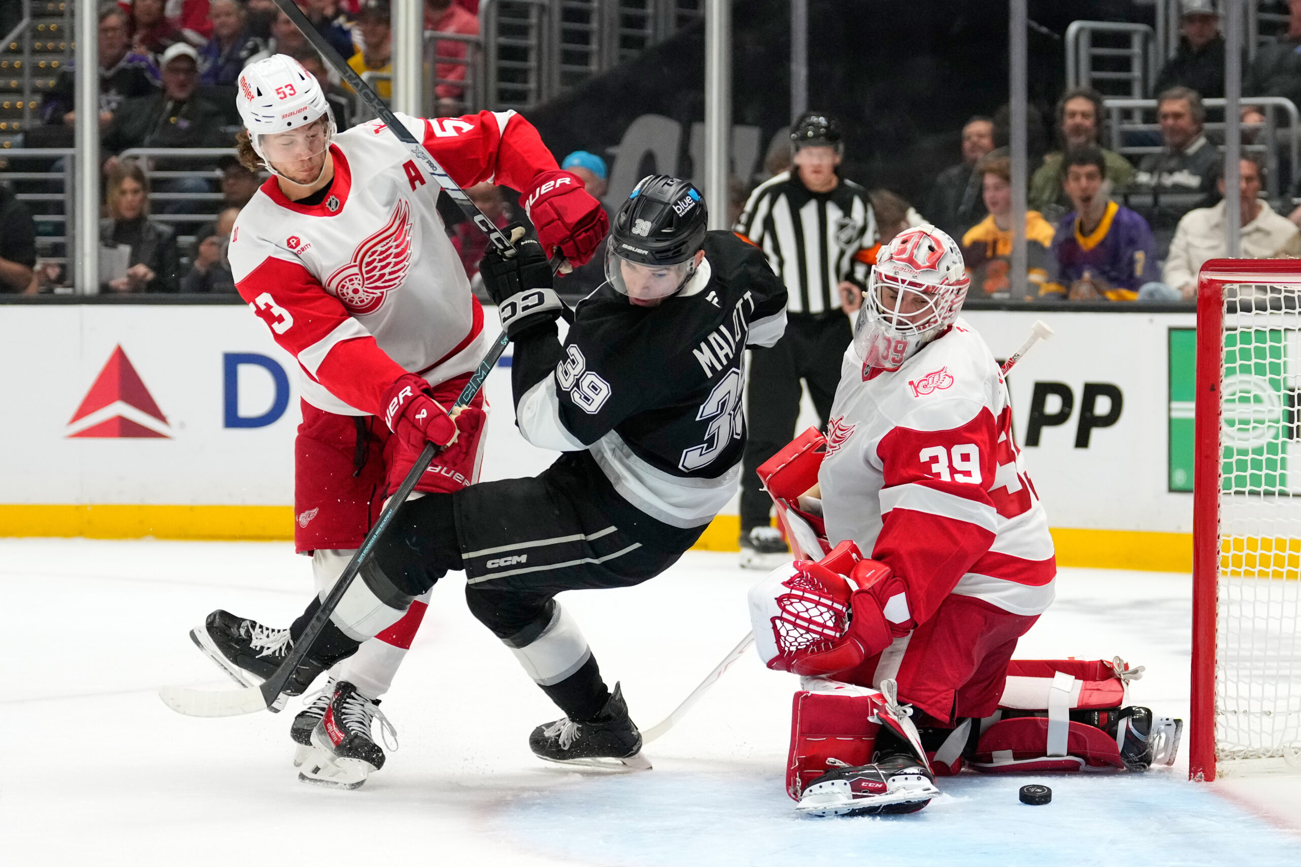 Kings left wing Jeff Malott, center, tries to score on...
