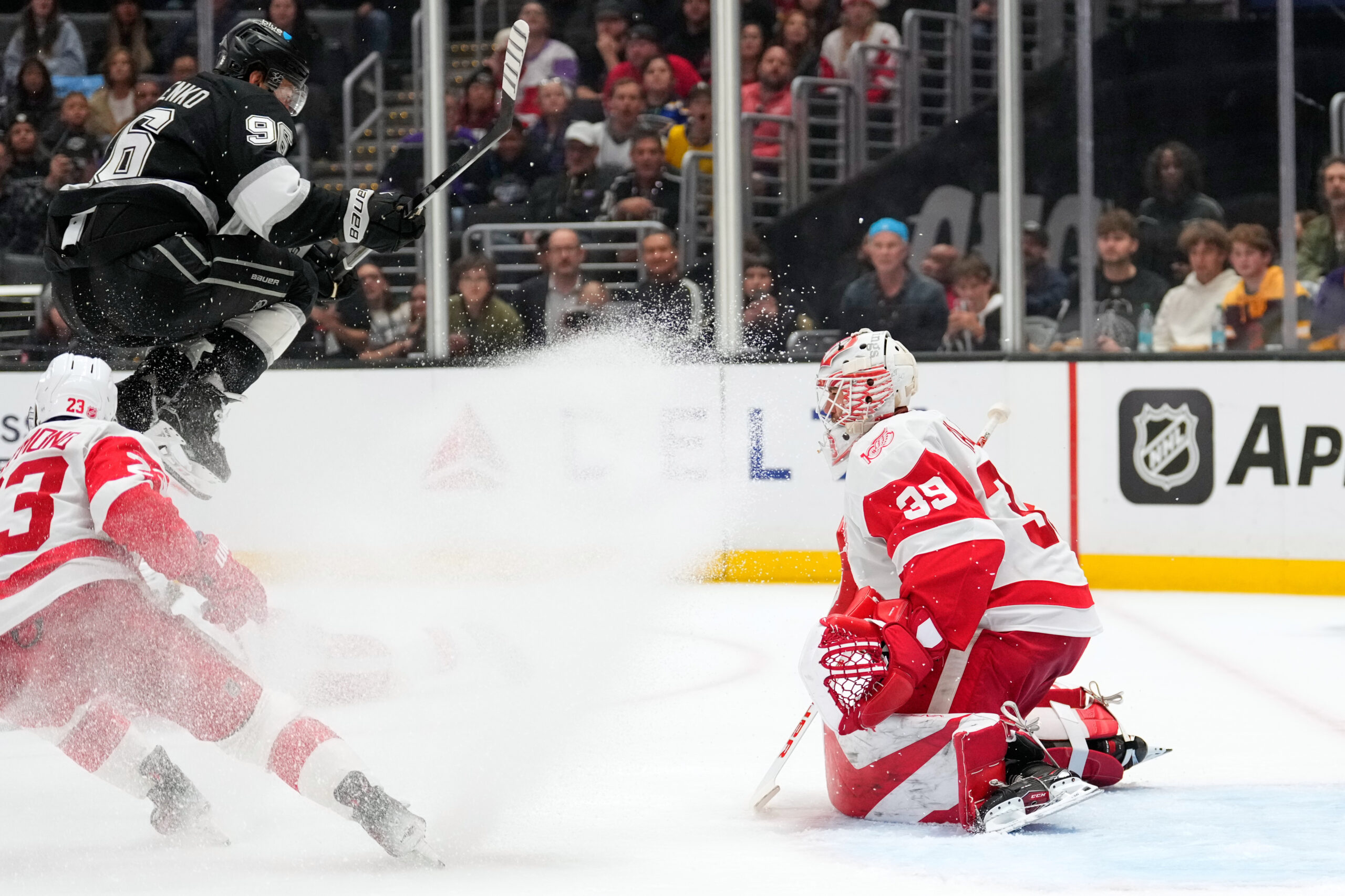 Kings left wing Andrei Kuzmenko, center, jumps out of the...