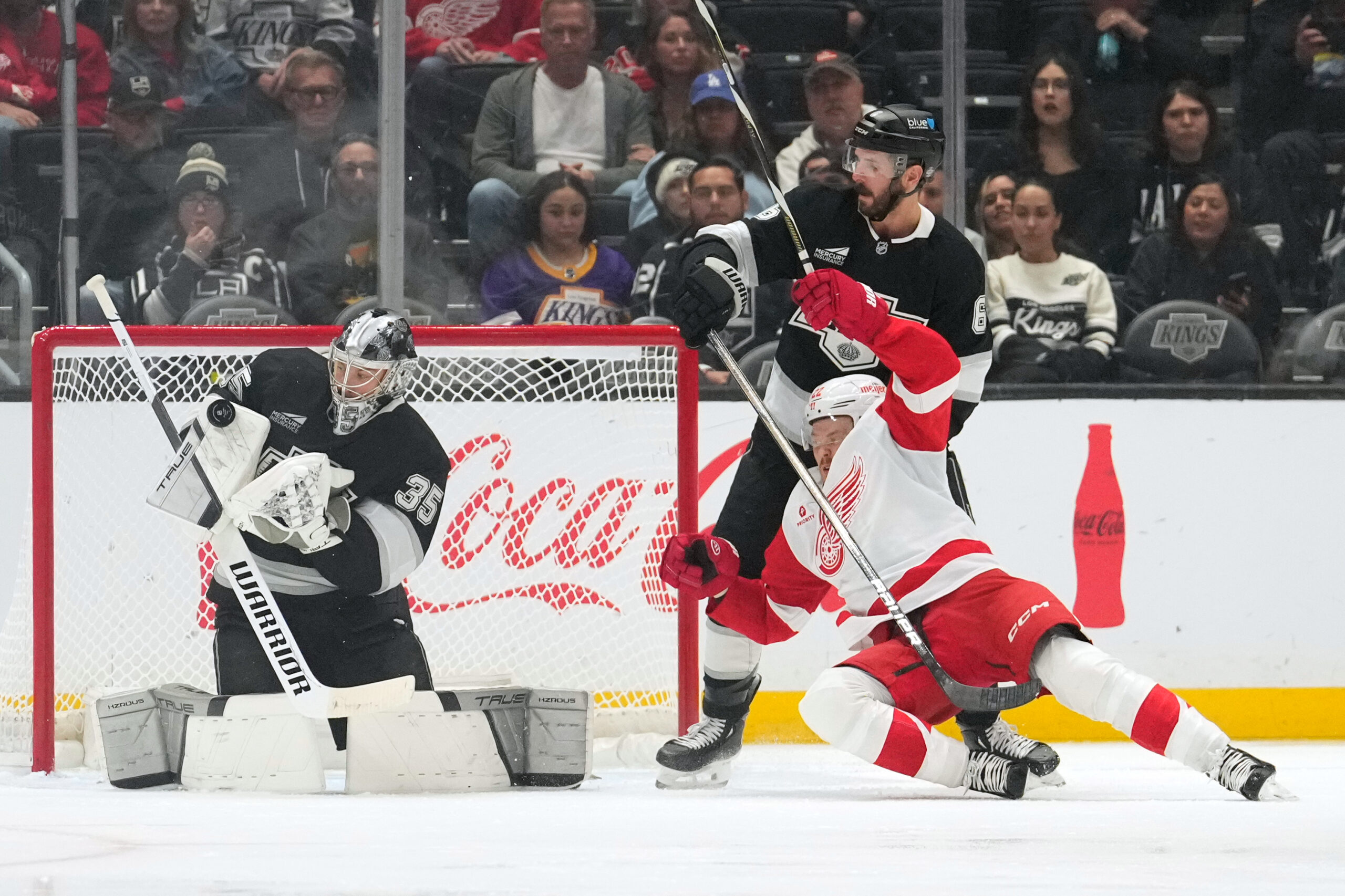 Kings goaltender Darcy Kuemper, left, deflects a shot as Detroit...