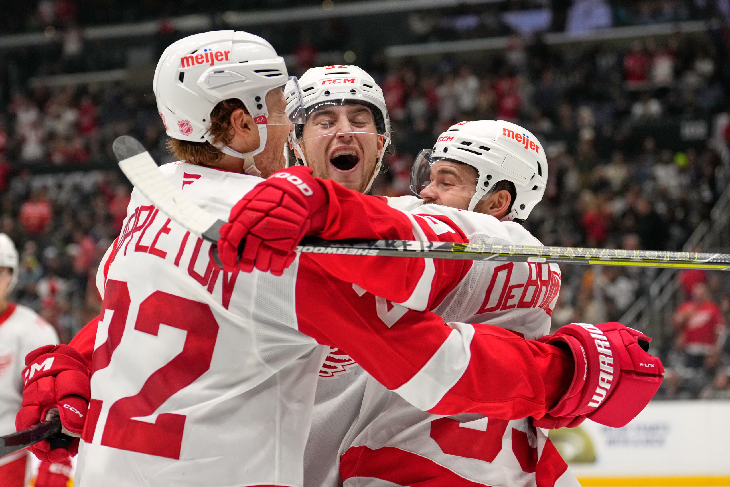 Detroit Red Wings center Marco Kasper, center, celebrates his goal...