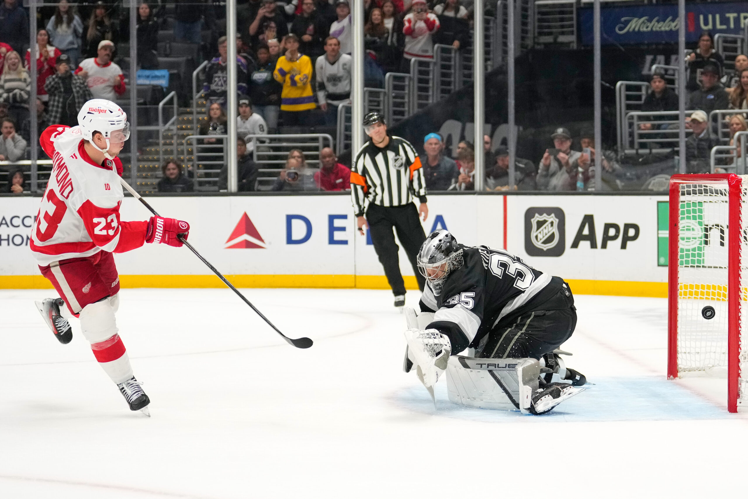 Detroit Red Wings left wing Lucas Raymond, left, scores past...