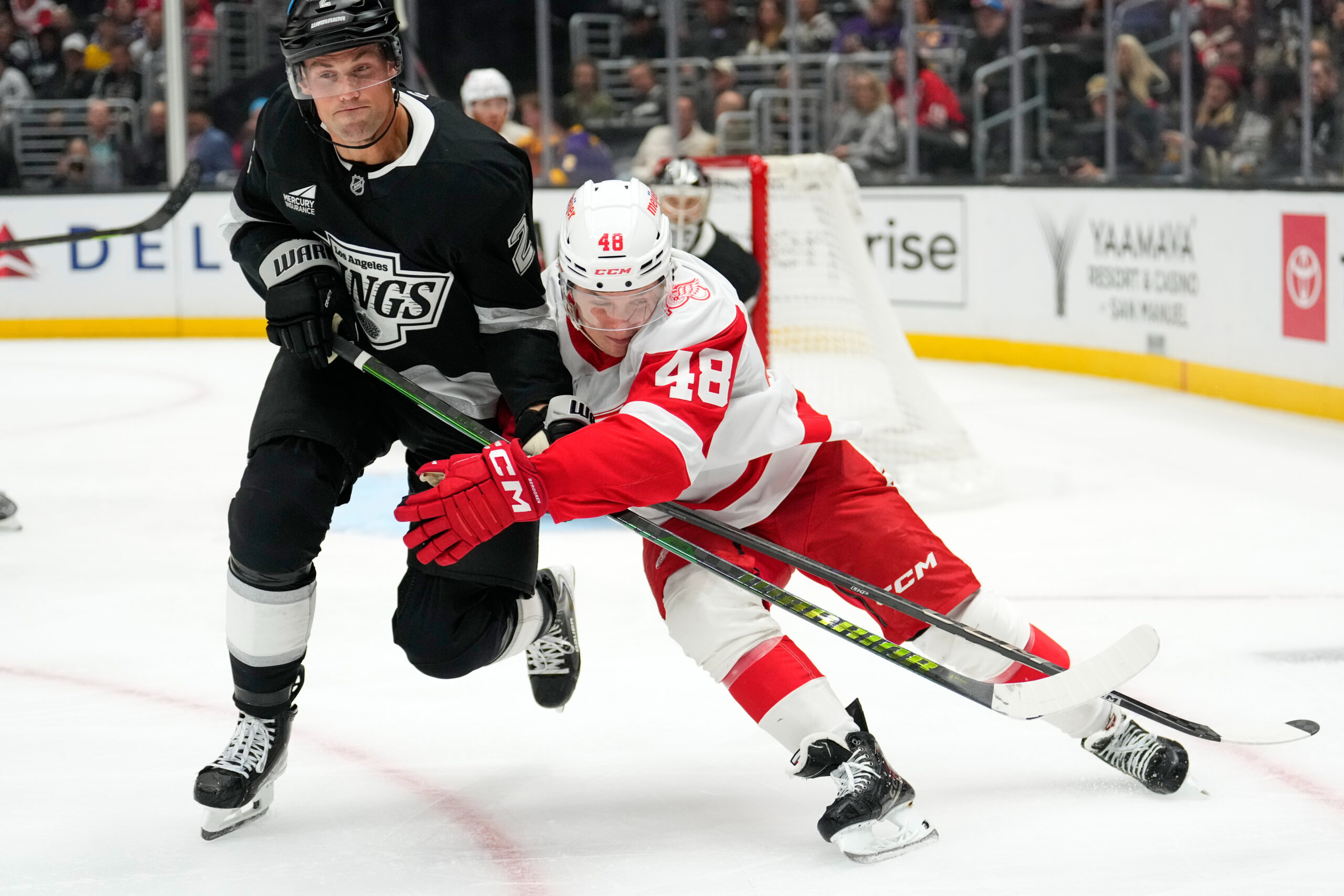 Kings defenseman Brian Dumoulin, left, and Detroit Red Wings right...