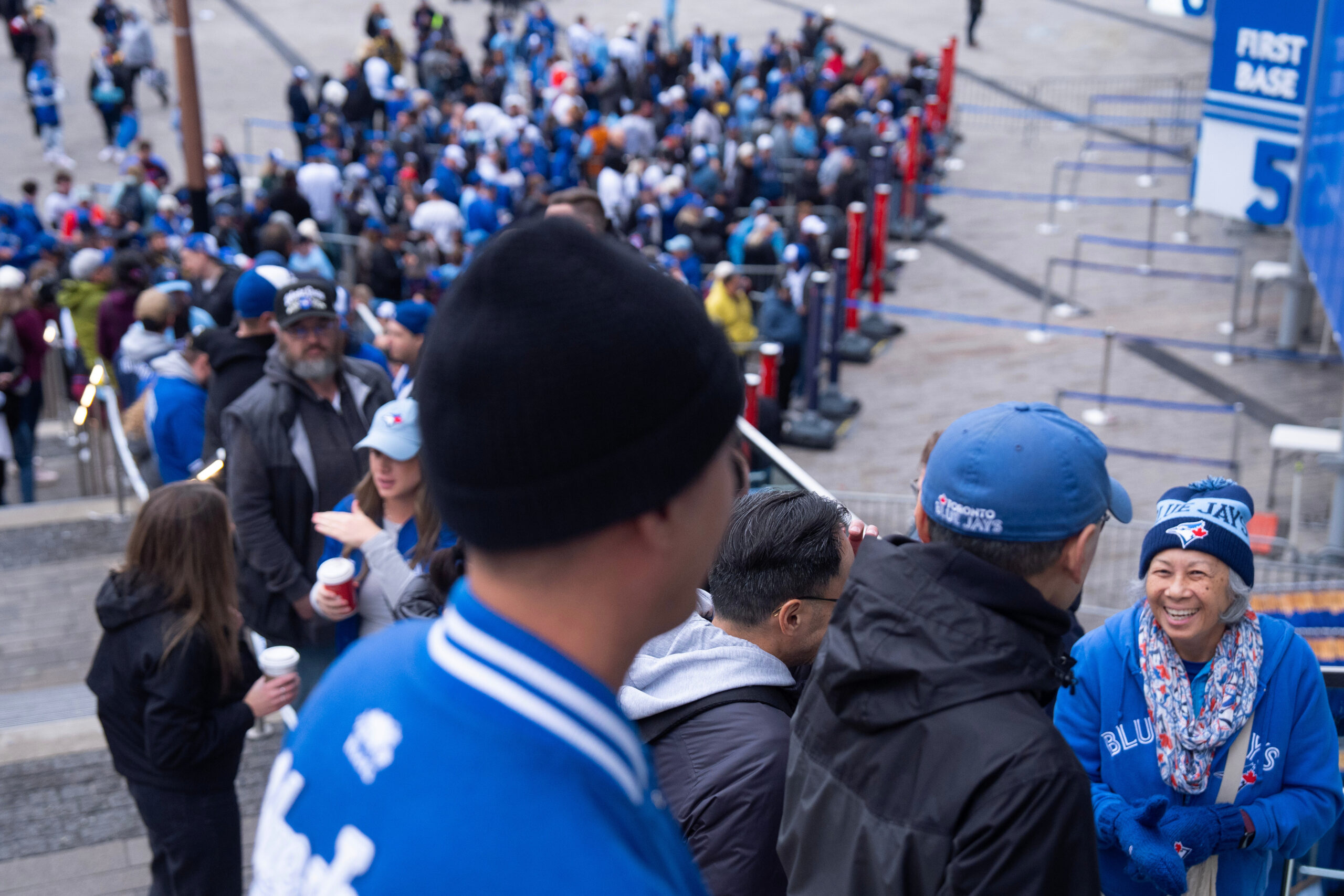 Toronto Blue Jays fans stand outside the Rogers Centre before...