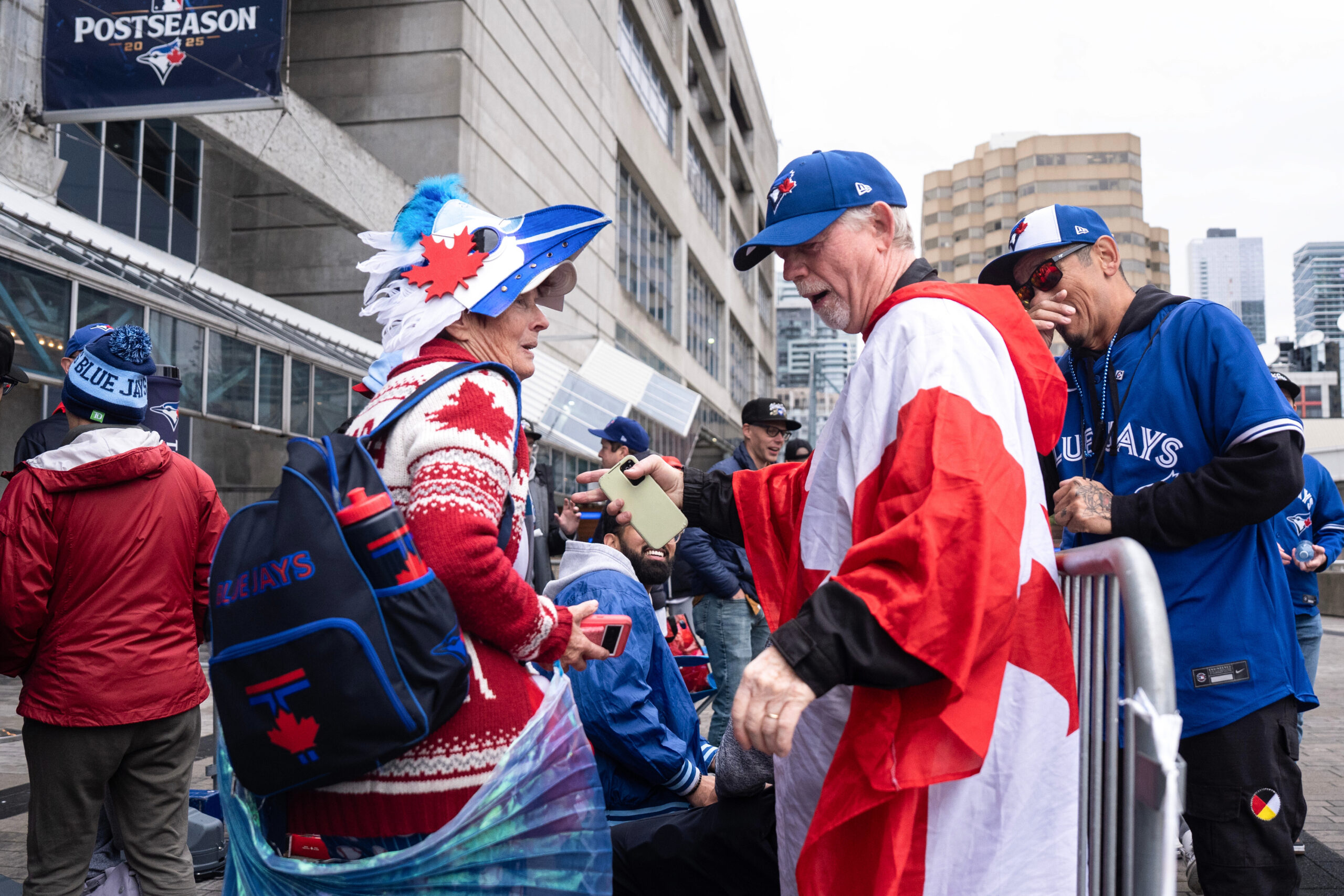 Toronto Blue Jays fans stand outside the Rogers Centre before...