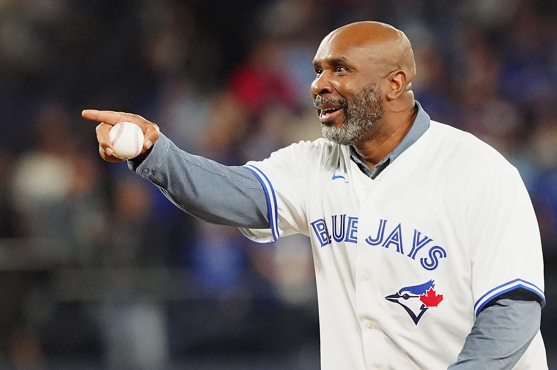 Former Toronto Blue Jays outfielder Devon White points to home...