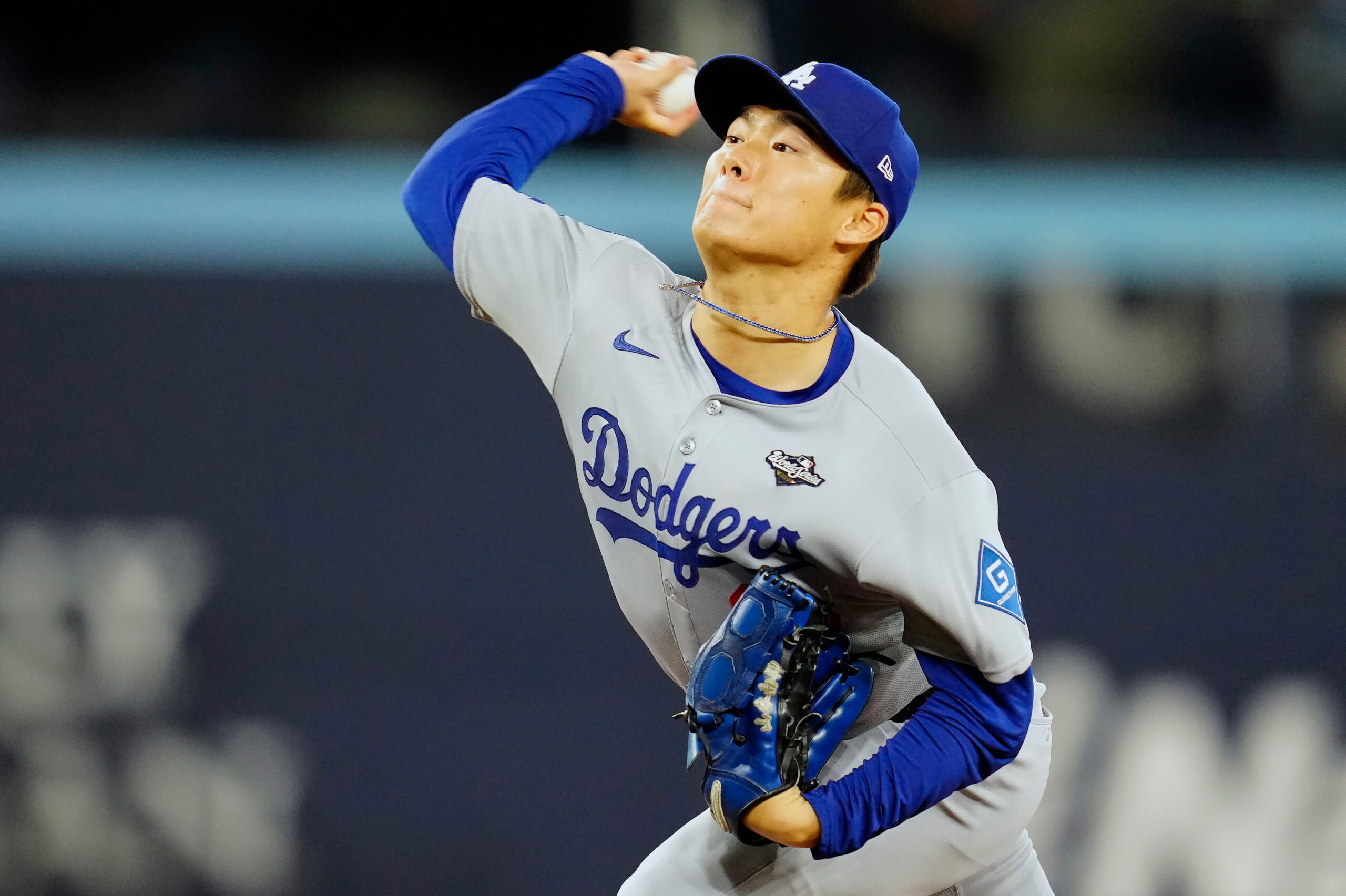Dodgers starting pitcher Yoshinobu Yamamoto throws to the plate against...