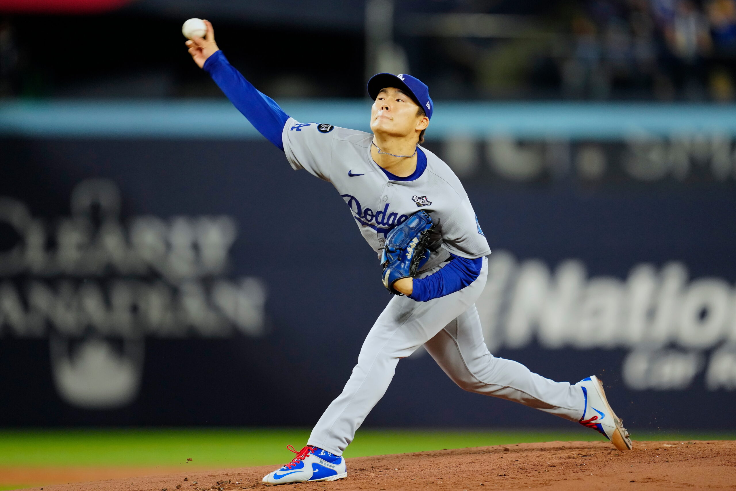 Dodgers starting pitcher Yoshinobu Yamamoto throws to the plate against...